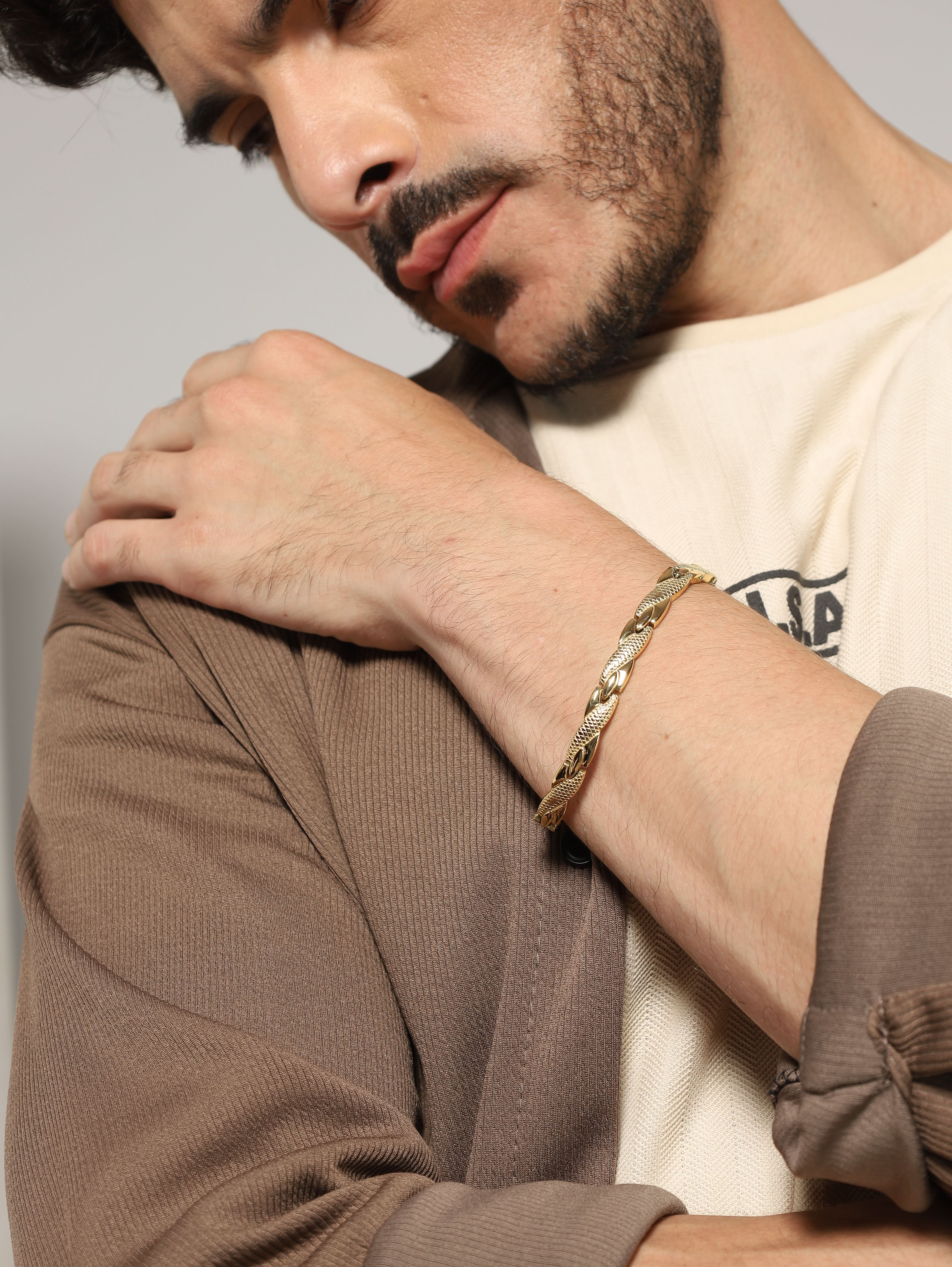 Close-up of Jewelor gold magnetic bracelet on a man's wrist