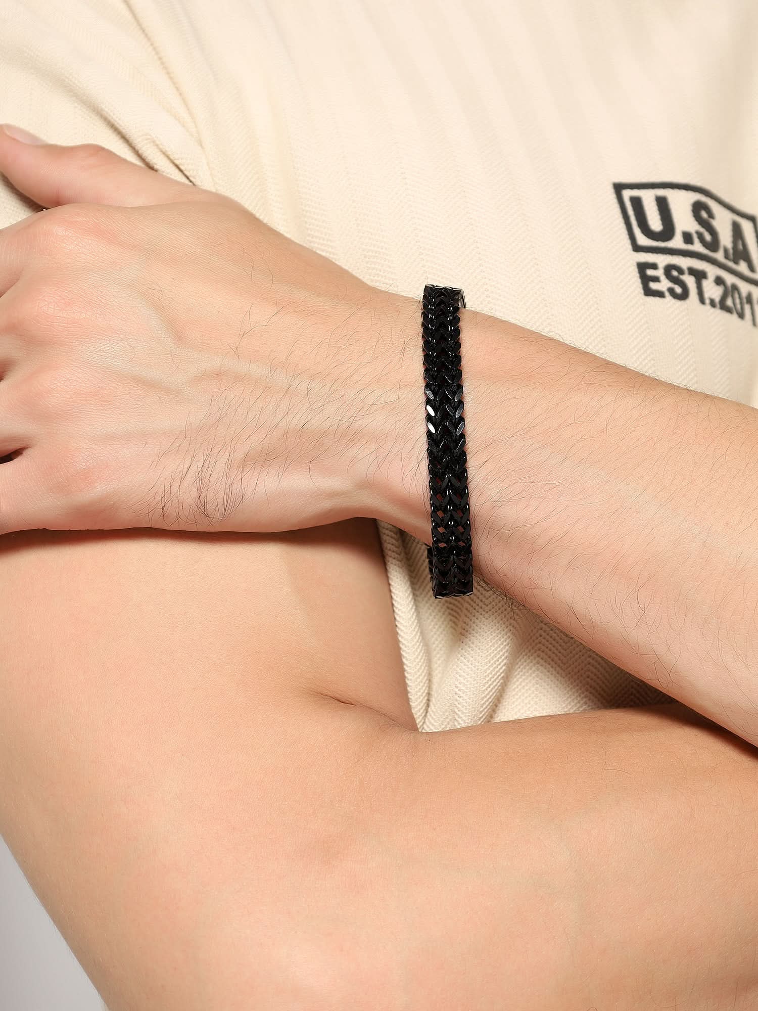 Side angle of black double-strand Franco bracelet styled on a man's wrist