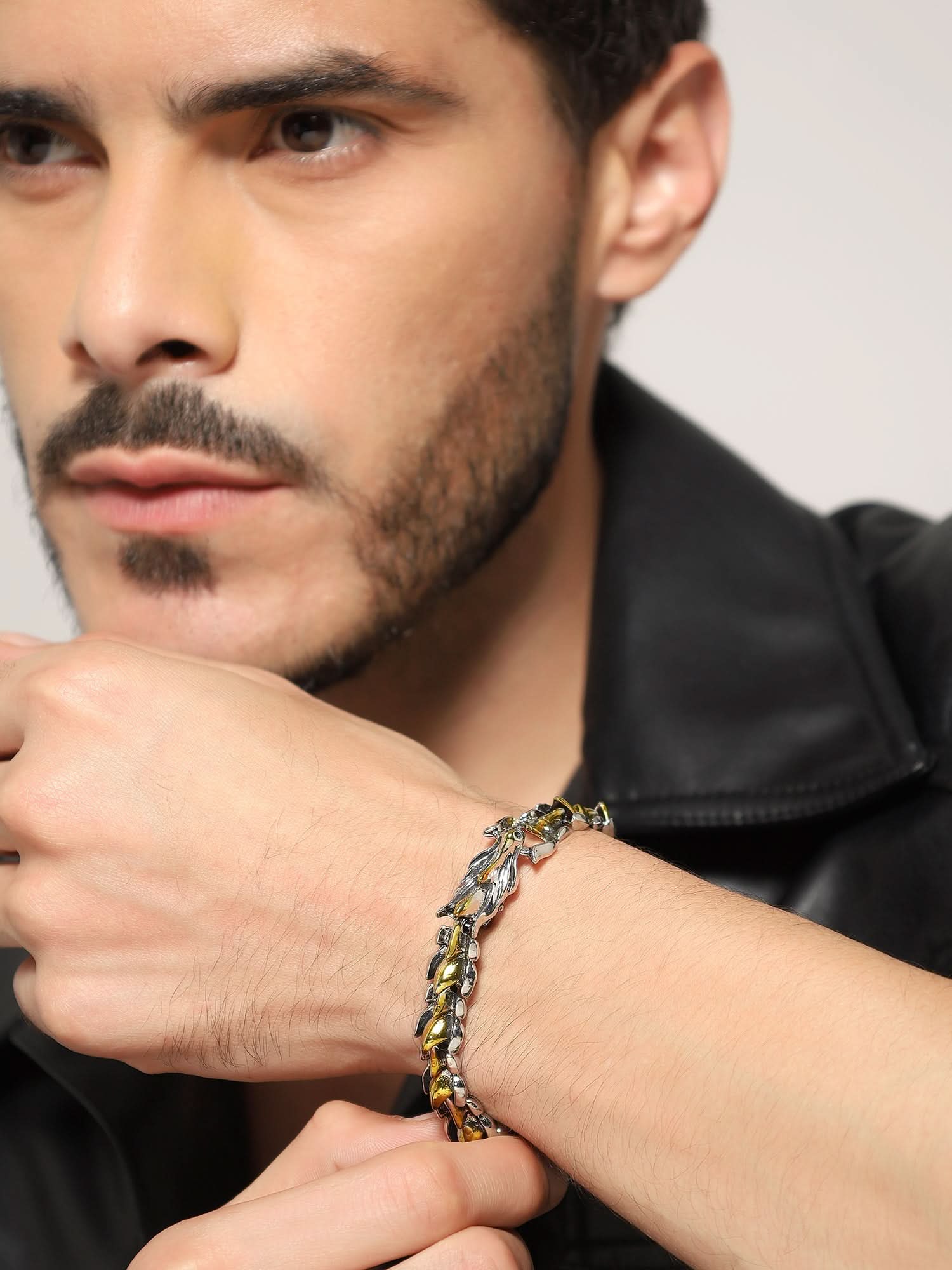 Side view of two-tone dragon bracelet styled on a man's wrist
