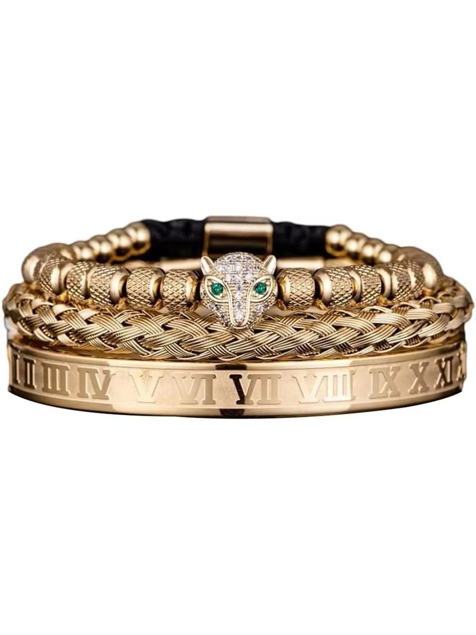 Flat-lay of Jewelor gold three-piece bracelet stack with leopard head bead and Roman numeral cuff