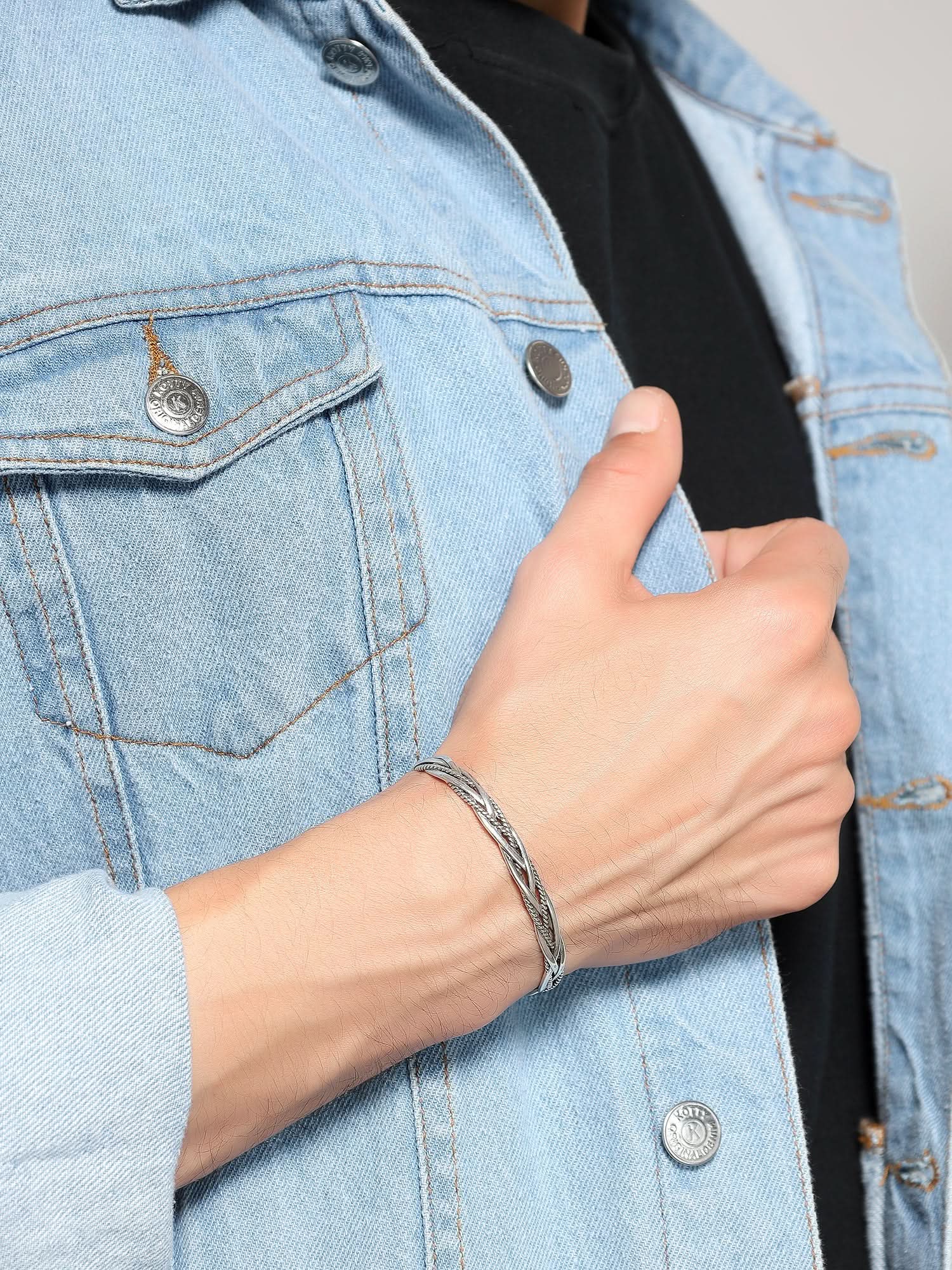 Side view of silver twisted rope cuff on a man's wrist
