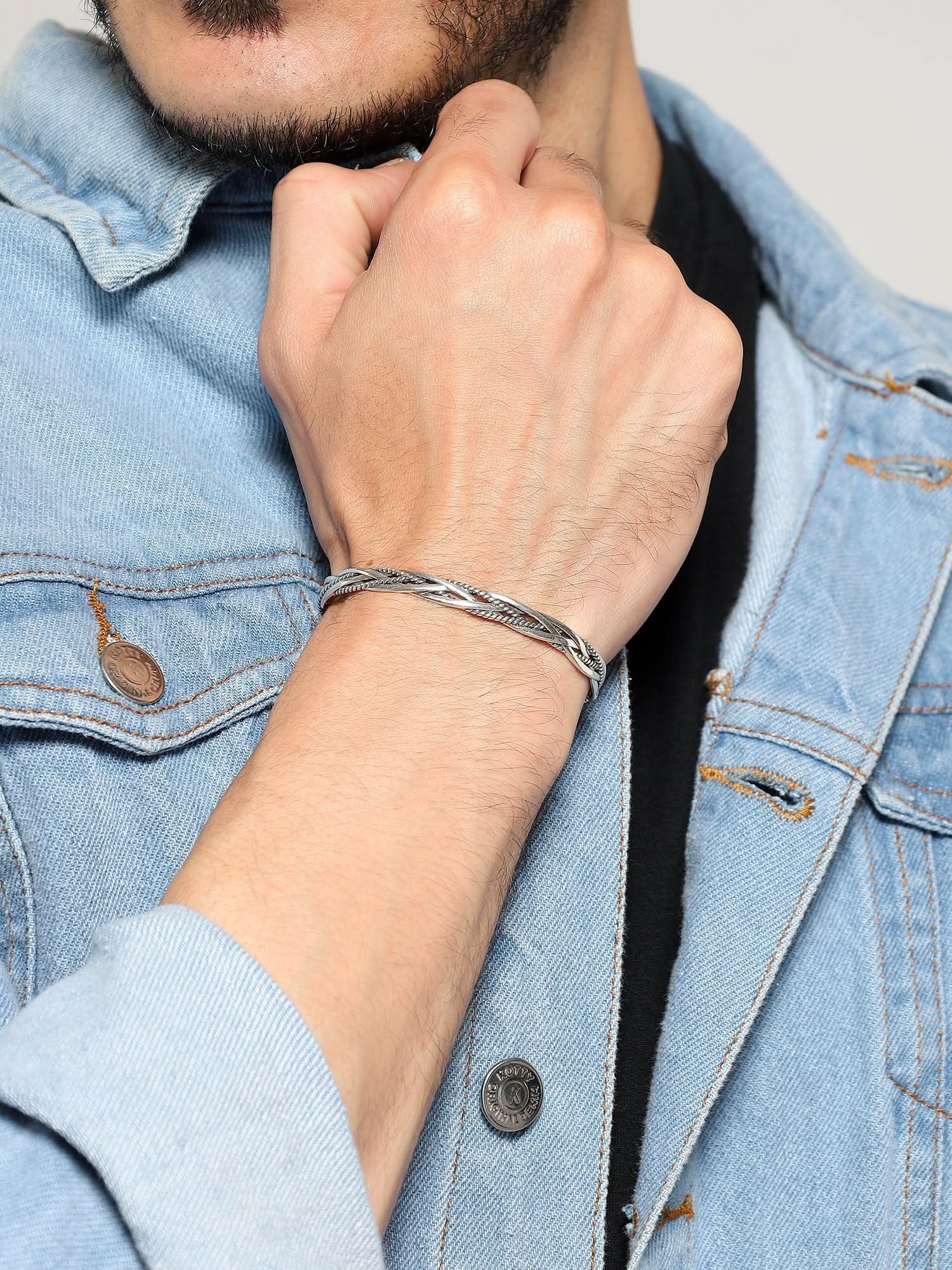 Close-up of silver twisted rope bracelet on a man's wrist