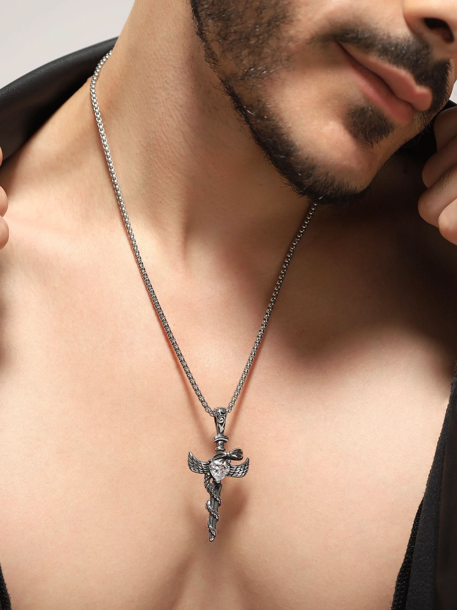 Model wearing Cross Snake Cubic Zircon Pendant in silver — men's silver pendant styled on hand