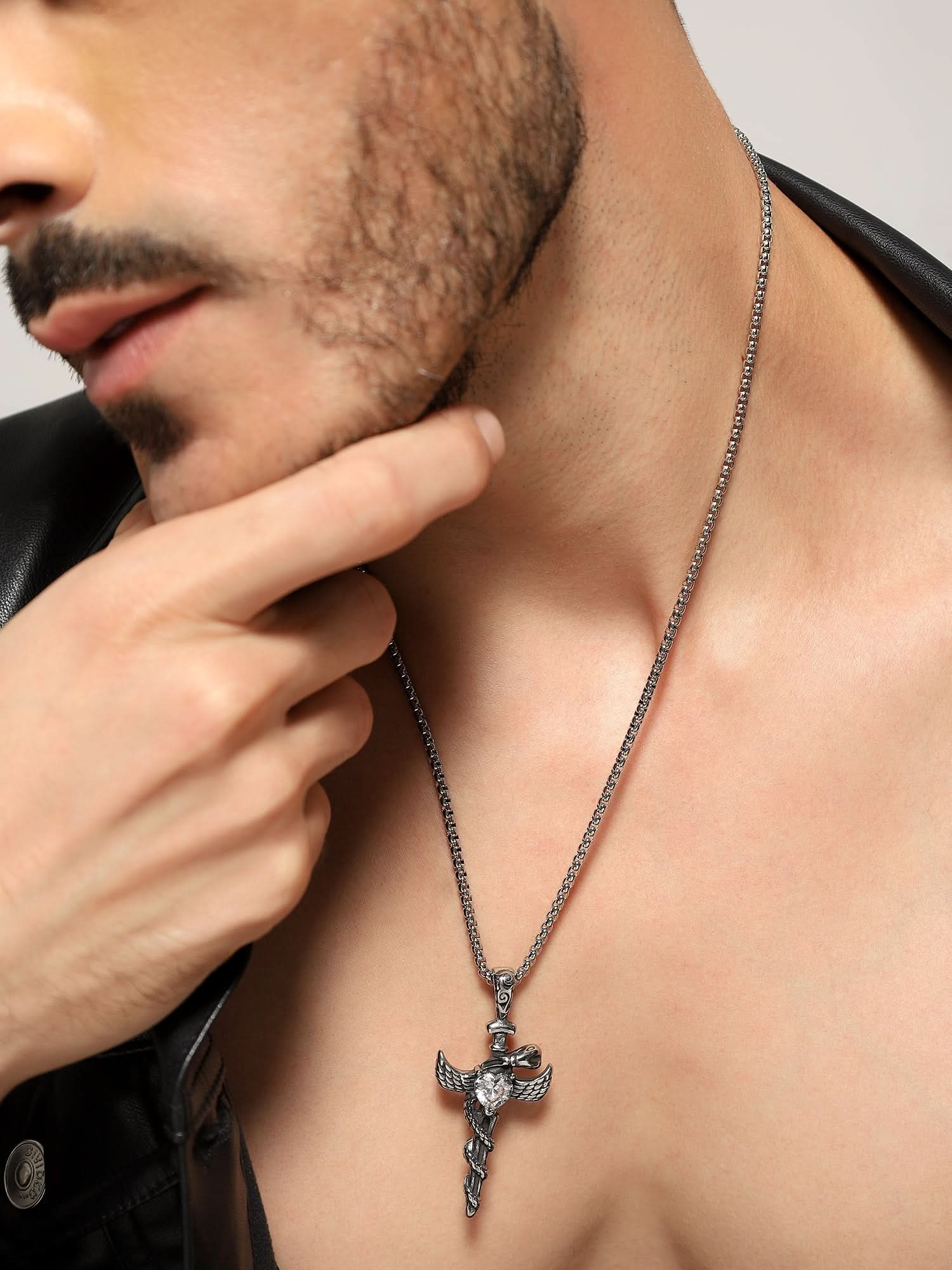 Model wearing Cross Snake Cubic Zircon Pendant in silver — men's silver pendant styled on hand