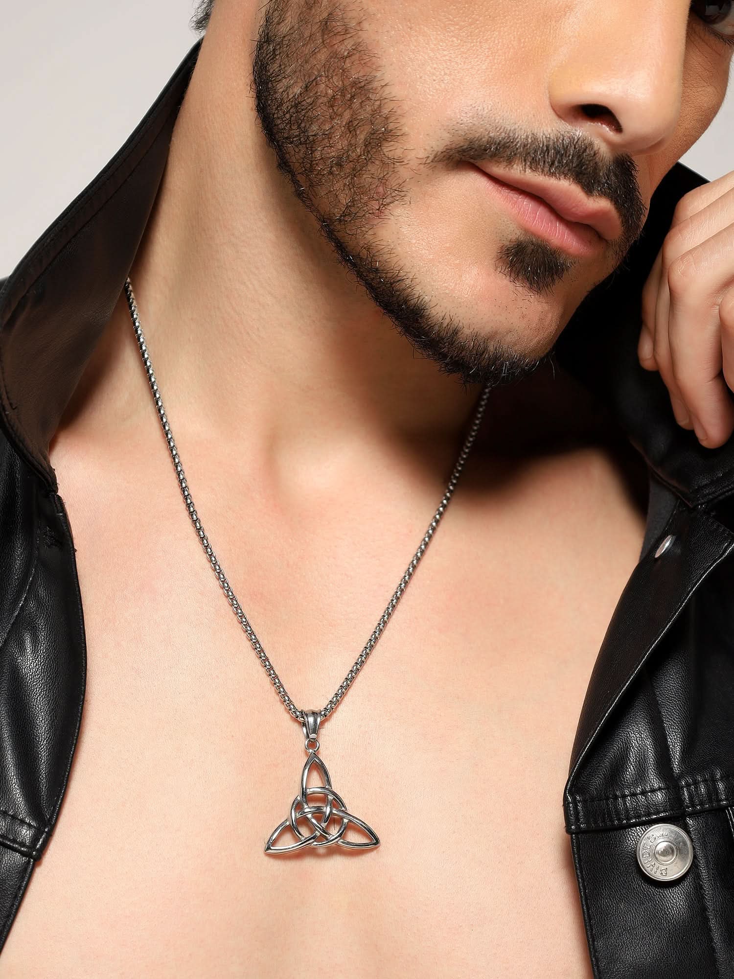 Model wearing Celtic Knot Pendant in silver — men's silver pendant styled on hand