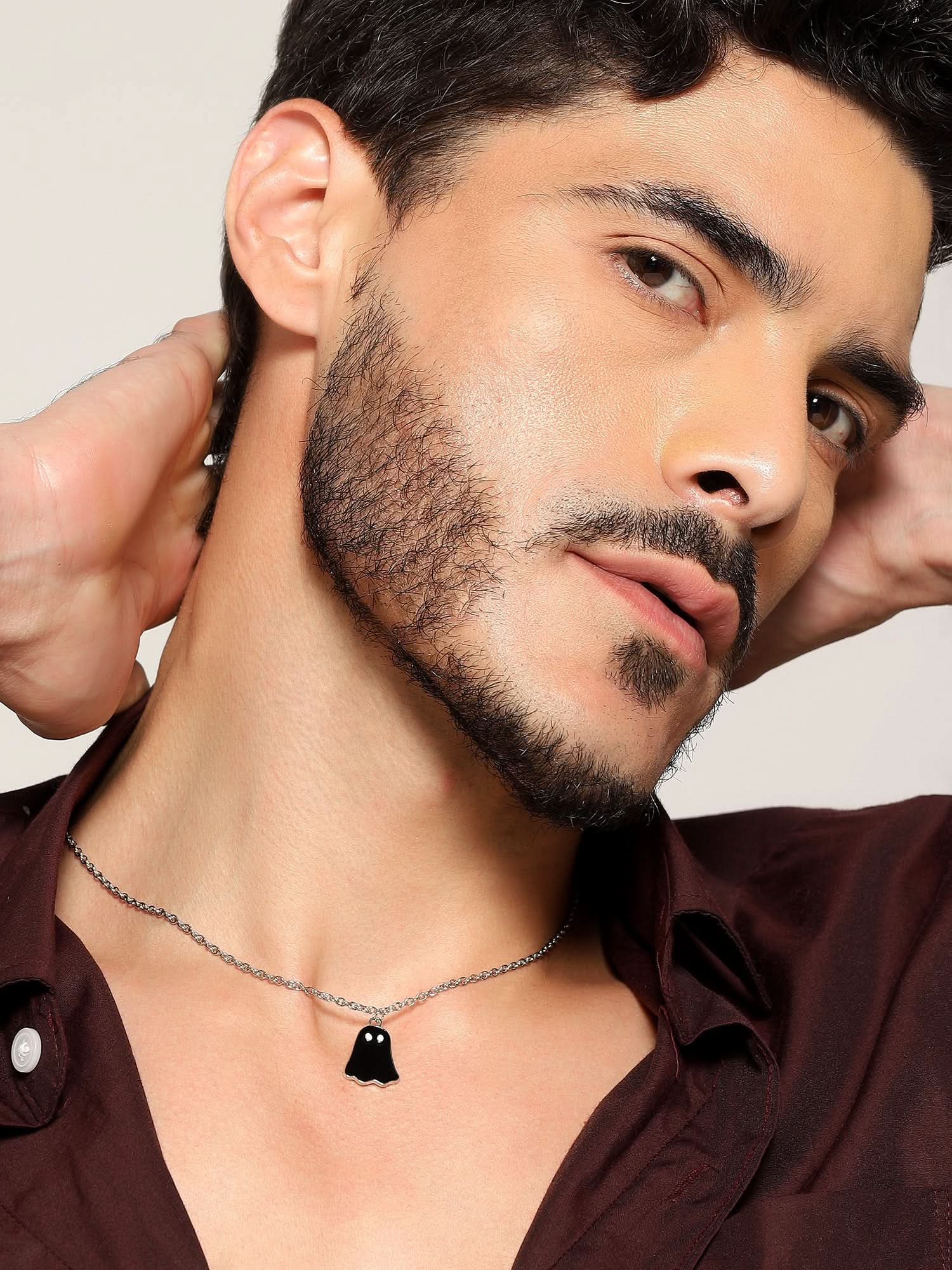 Model wearing Halloween Cute Cartoon Ghost Pendant in black — men's black pendant styled on hand