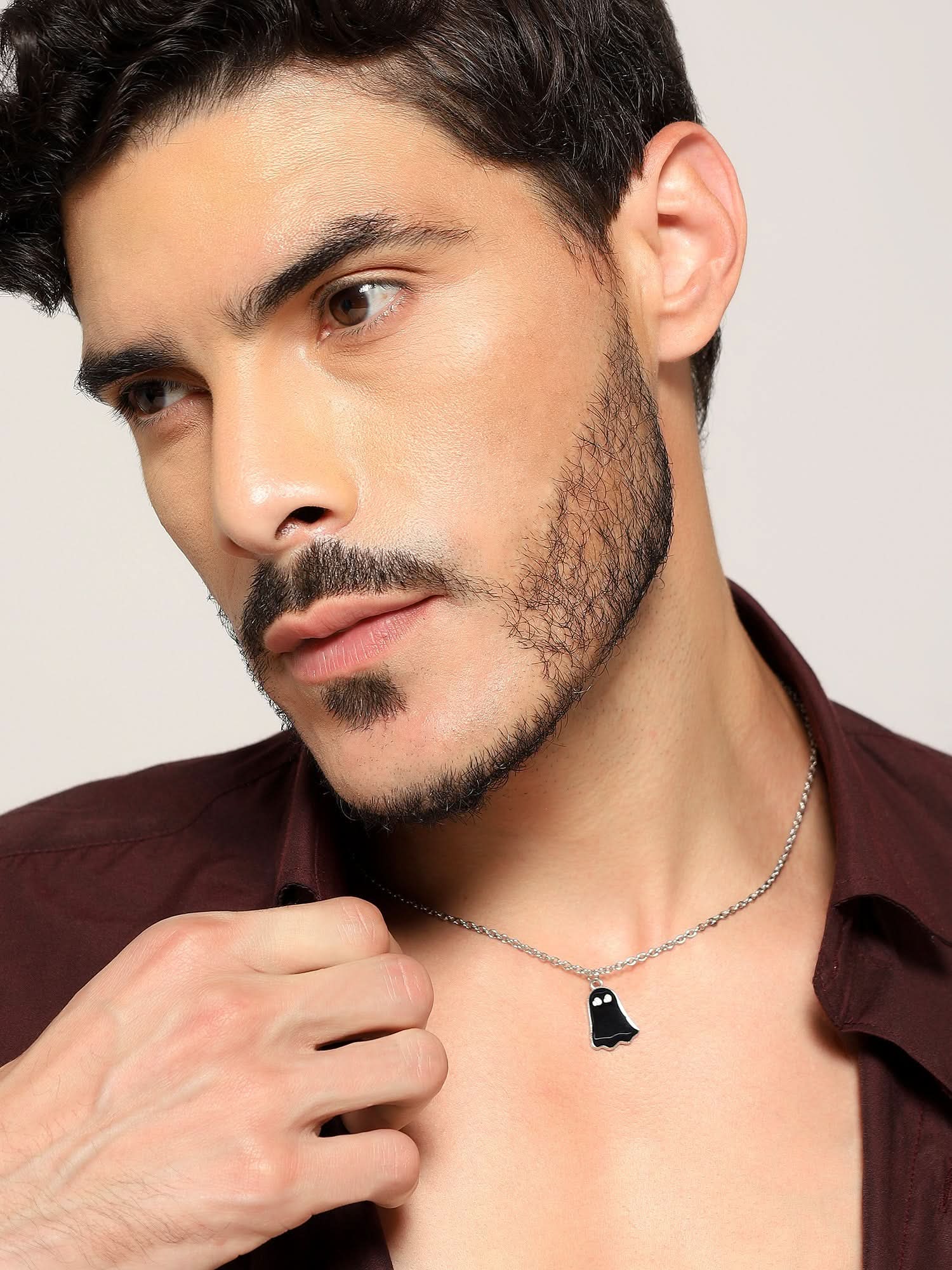 Model wearing Halloween Cute Cartoon Ghost Pendant in black — men's black pendant styled on hand