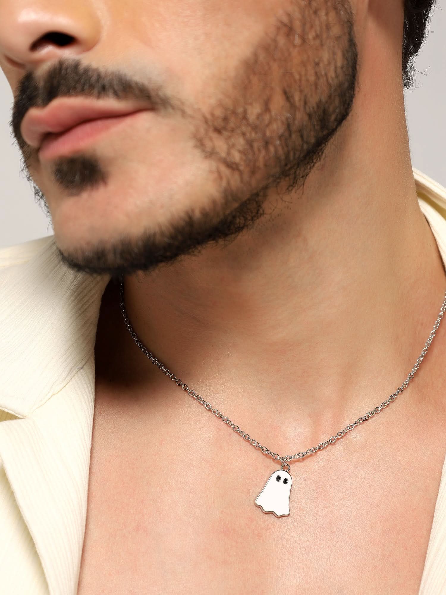 Model wearing Halloween Cute Cartoon Ghost Pendant in white — men's white pendant styled on hand