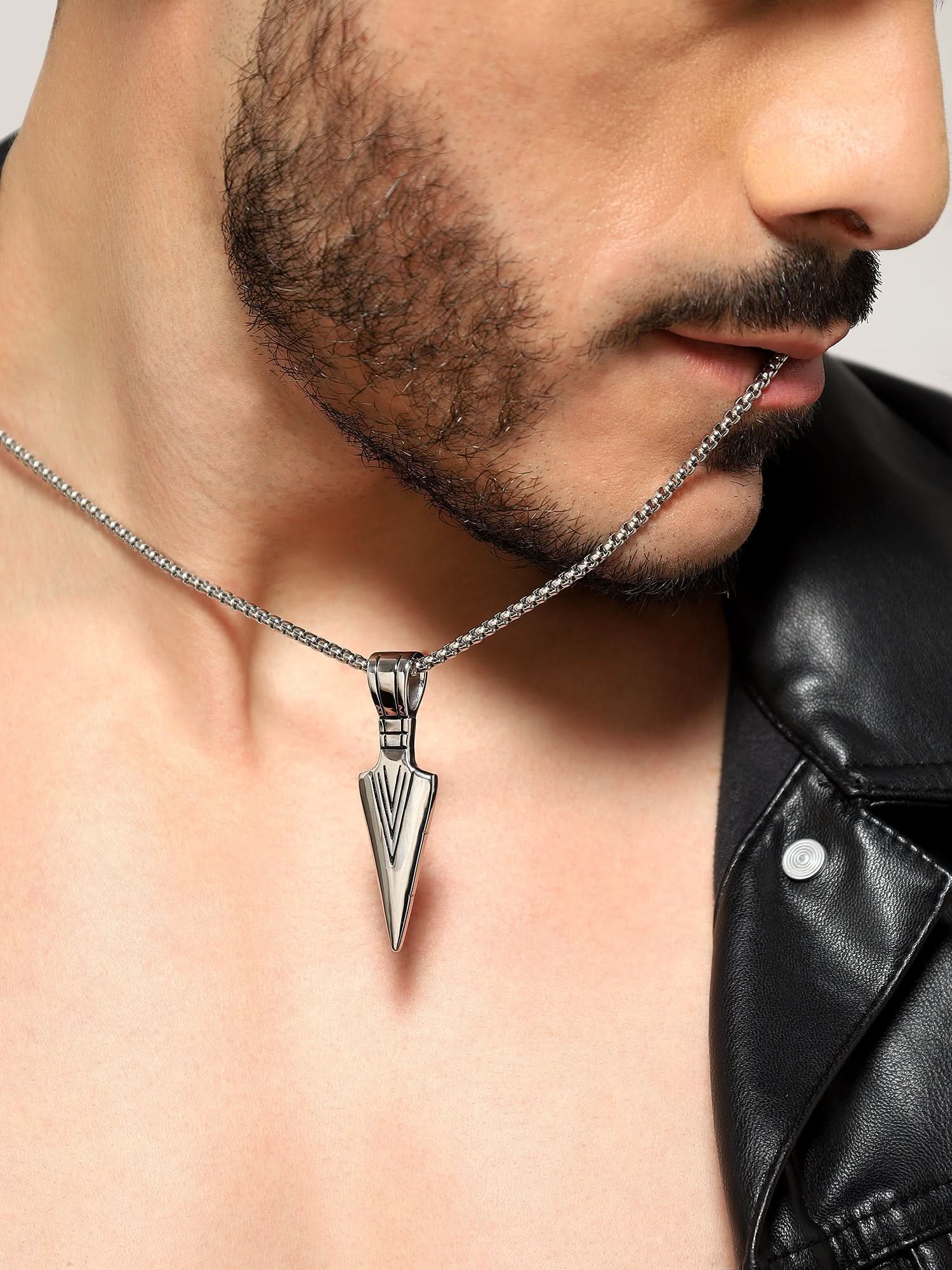 Model wearing Punk Arrow Pendant in silver — men's silver pendant styled on hand