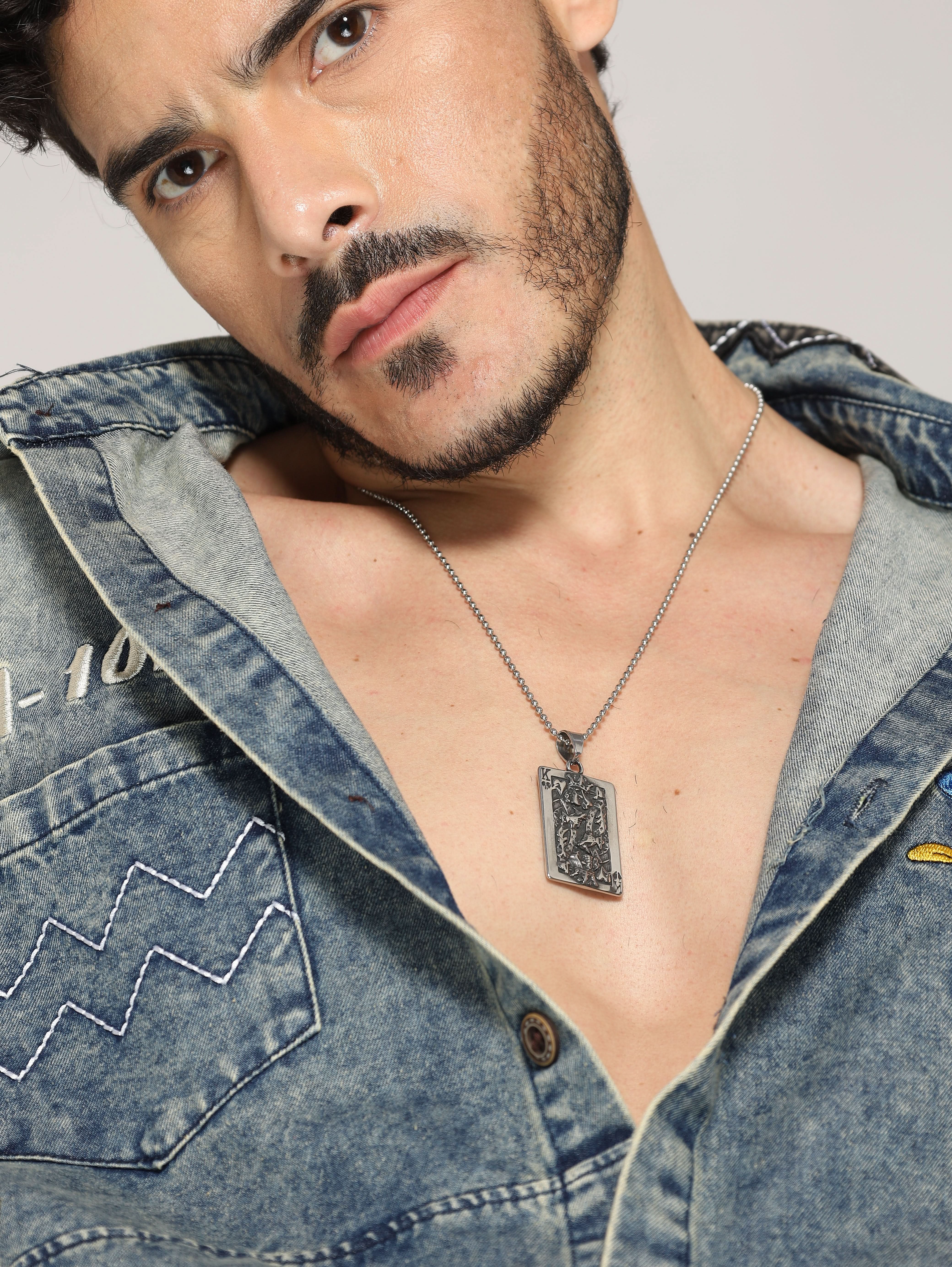 Model wearing Poker King Pendant in silver — men's silver pendant styled on hand