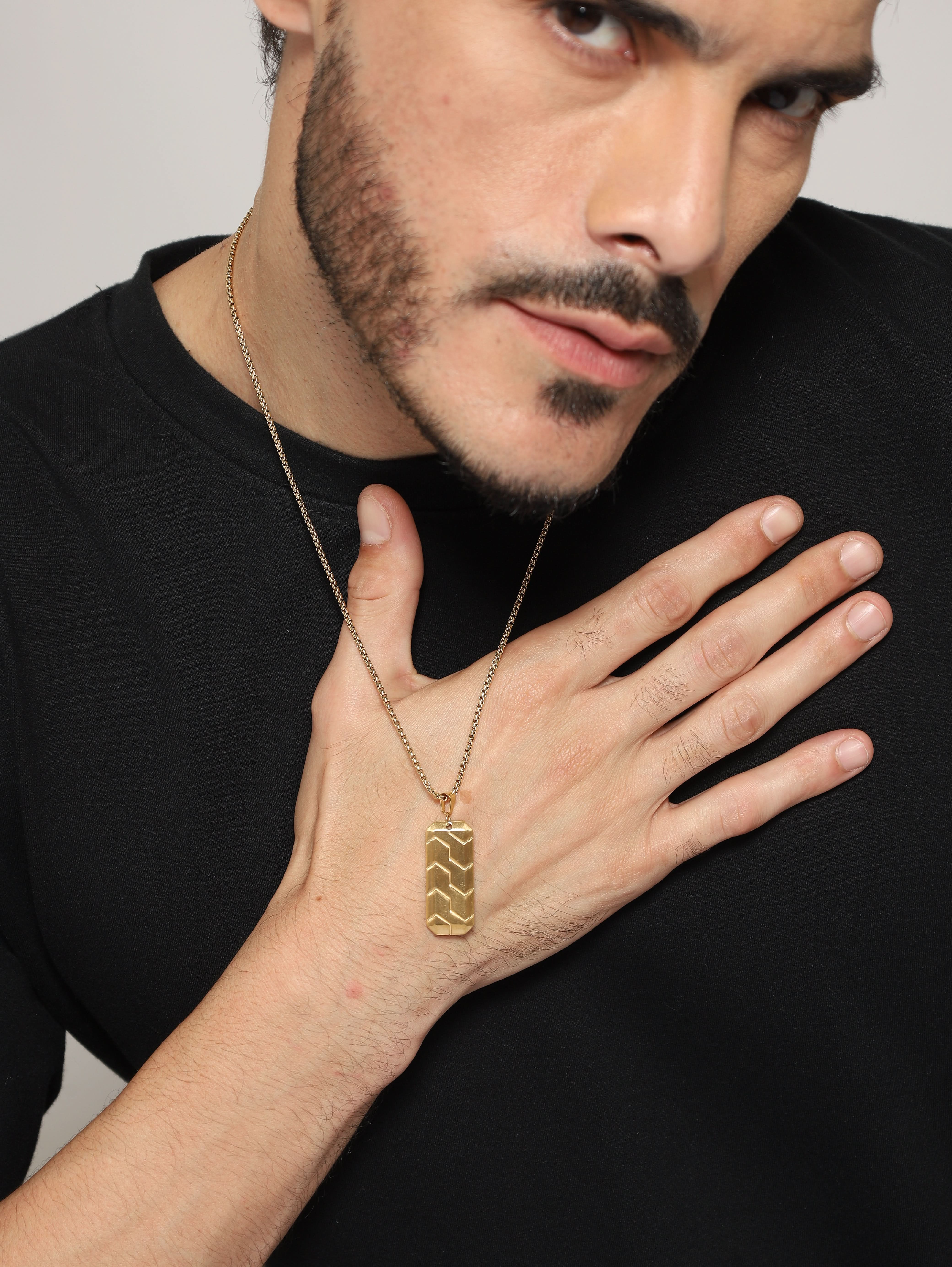 Model wearing Hexagonal 3D Diagonal Tire Pendant in gold — men's gold pendant styled on hand