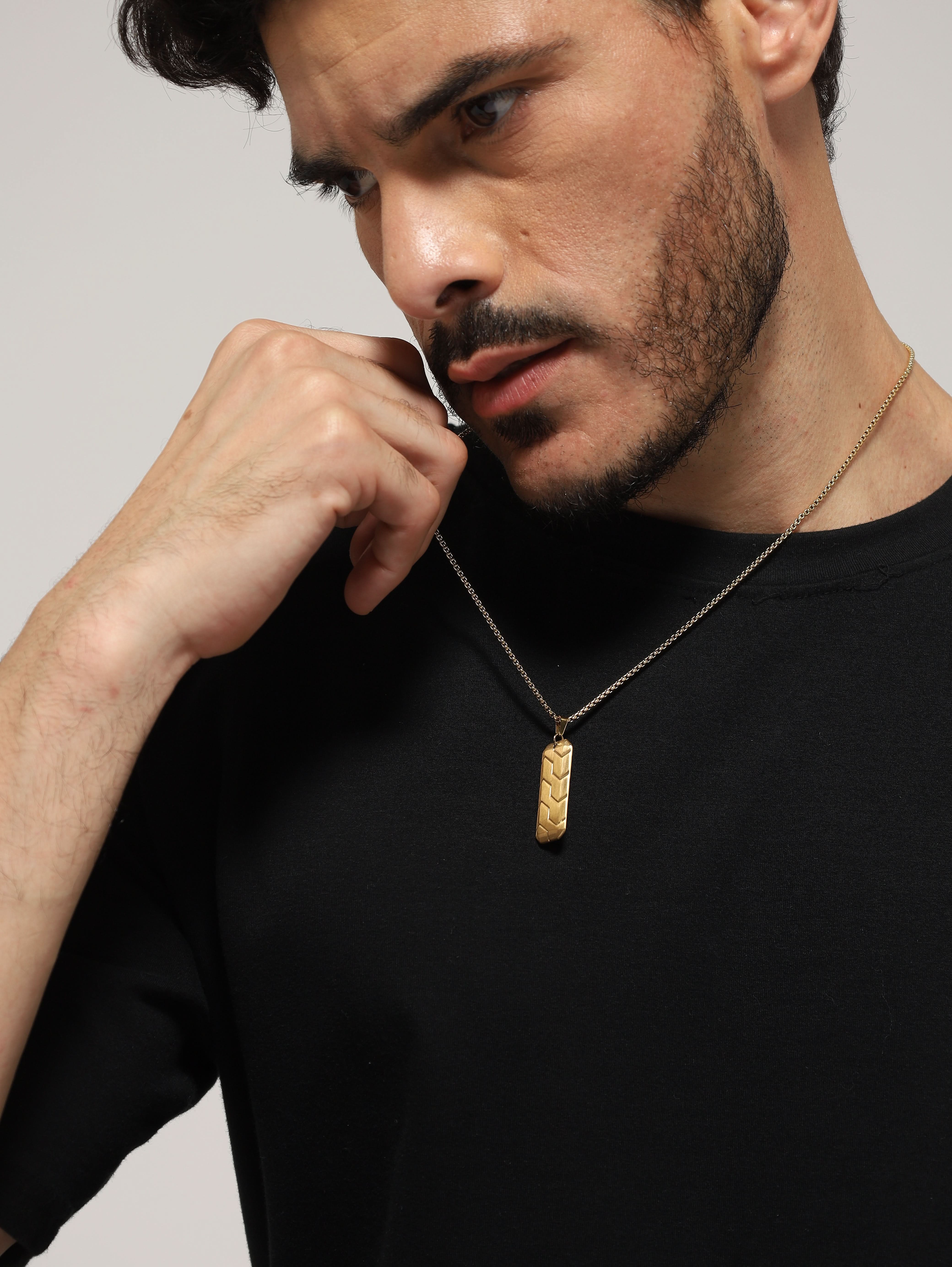 Model wearing Hexagonal 3D Diagonal Tire Pendant in gold — men's gold pendant styled on hand