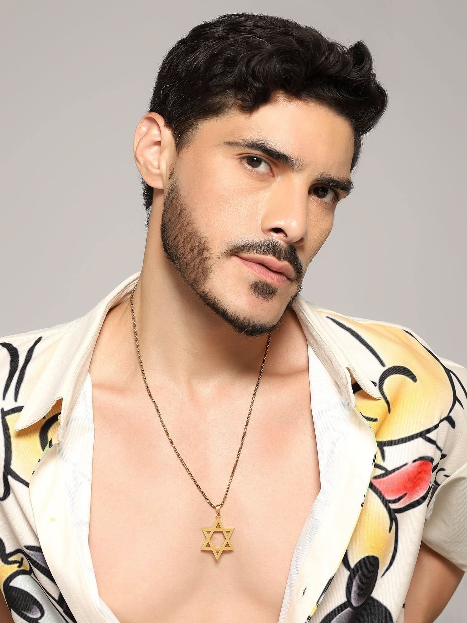 Model wearing Six Pointed Star Pendant in gold — men's gold pendant styled on hand