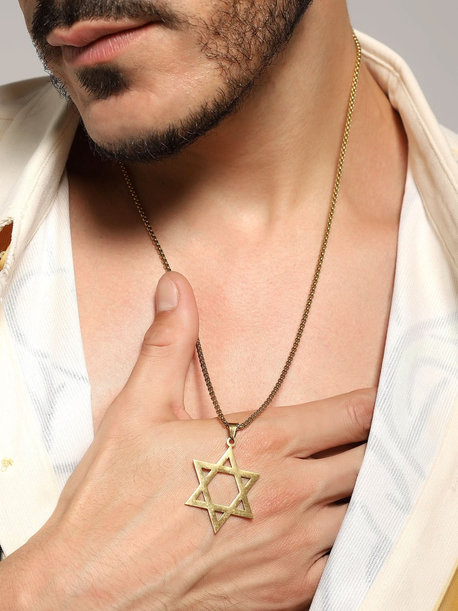 Model wearing Six Pointed Star Pendant in gold — men's gold pendant styled on hand