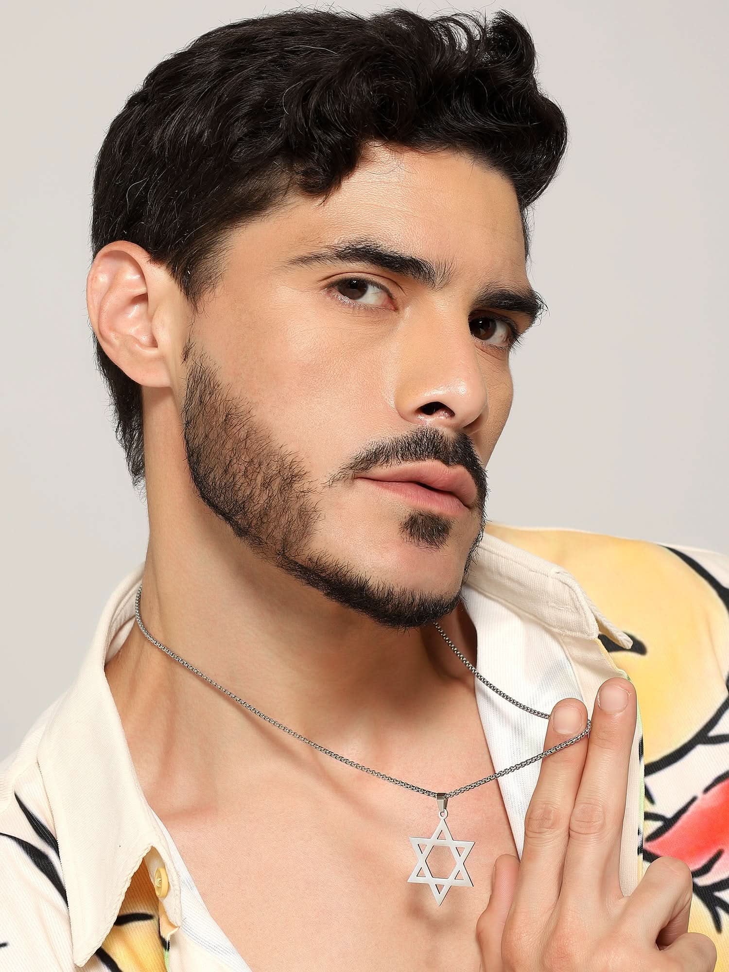 Model wearing Six Pointed Star Pendant in silver — men's silver pendant styled on hand