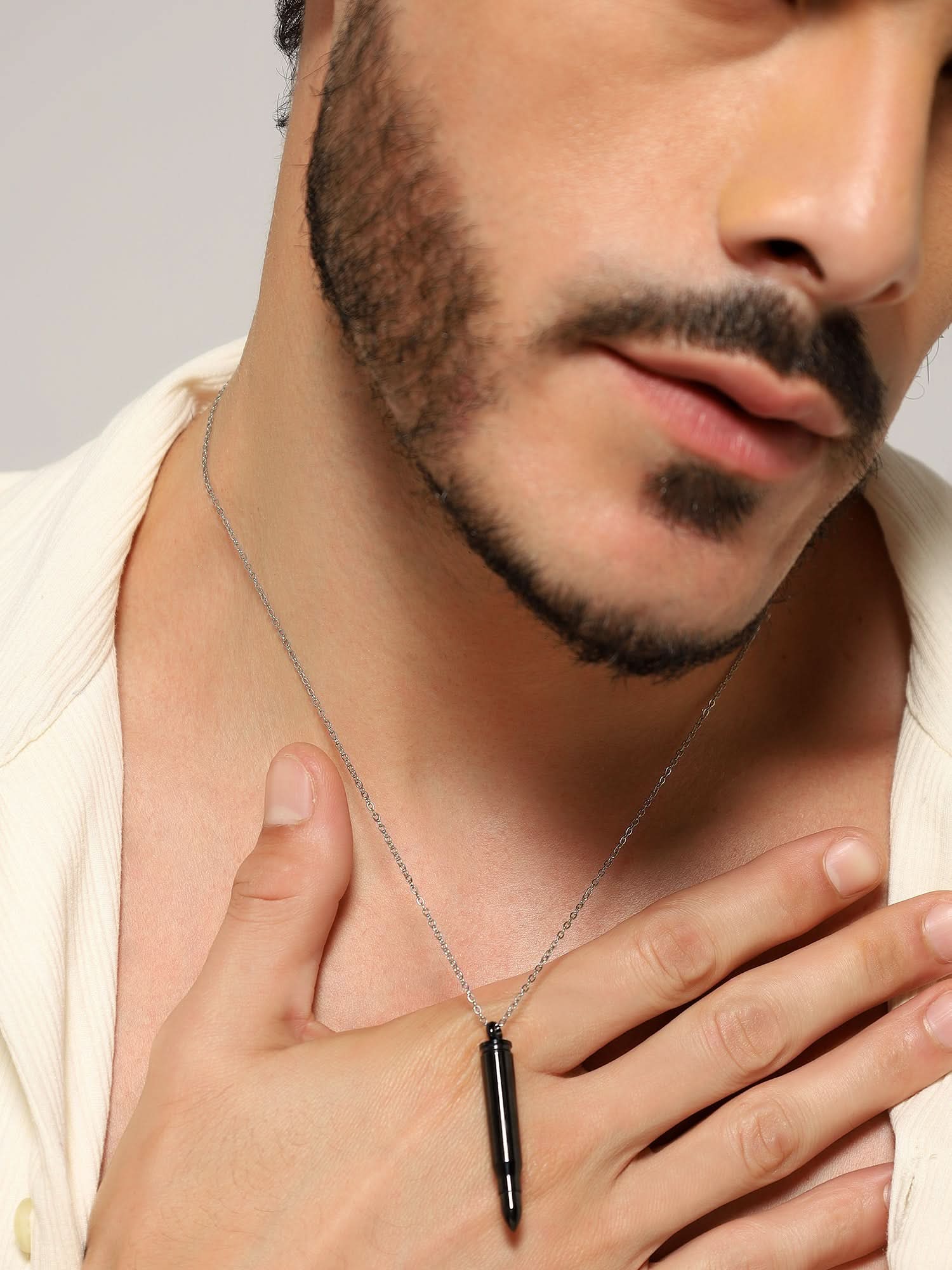 Model wearing Bullet Head Pendant in black — men's black pendant styled on hand
