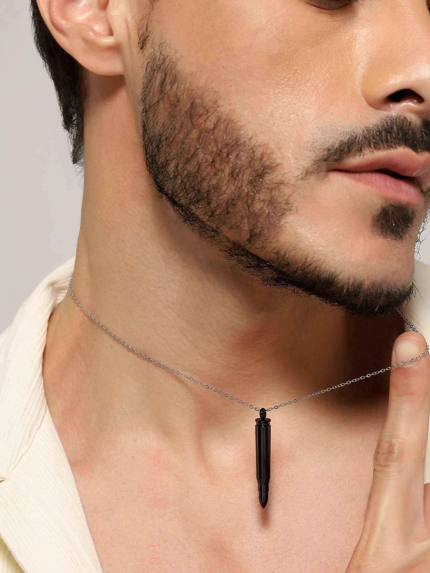 Model wearing Bullet Head Pendant in black — men's black pendant styled on hand