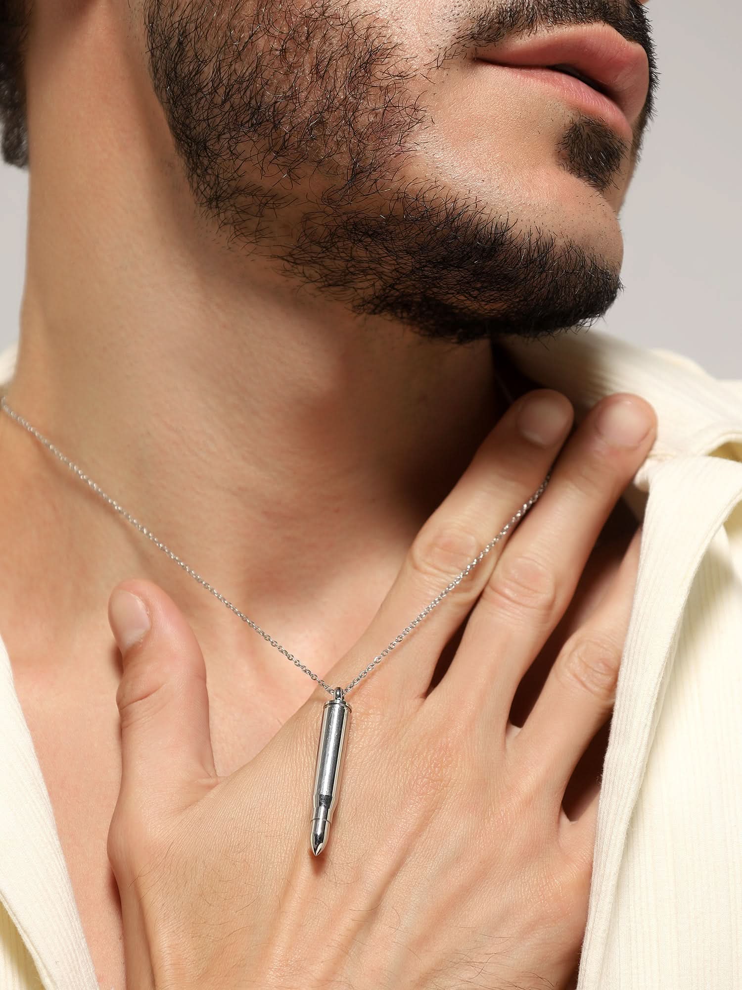 Model wearing Bullet Head Pendant in silver — men's silver pendant styled on hand