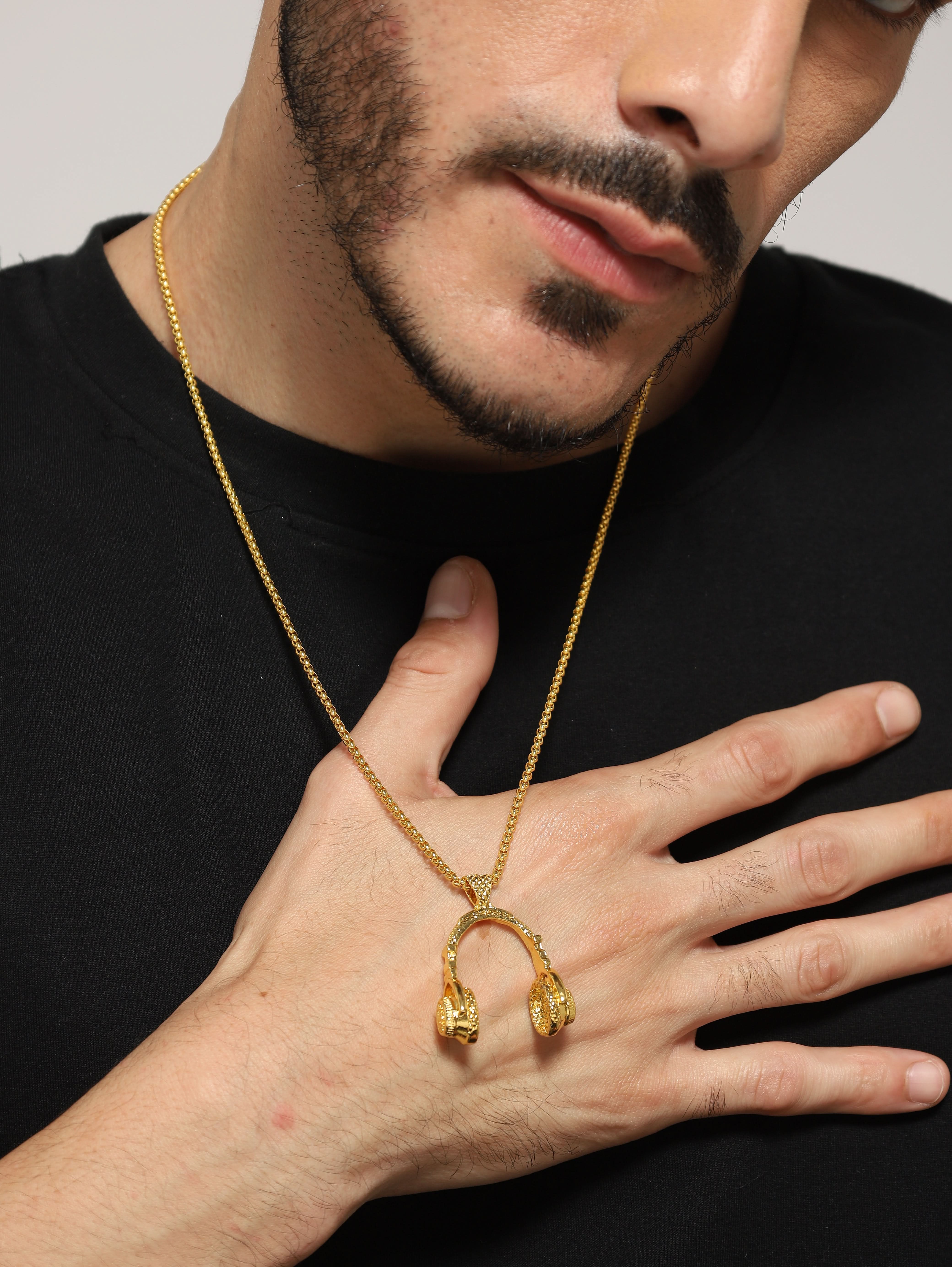 Model wearing DJ Music Phone Pendant in gold — men's gold pendant styled on hand