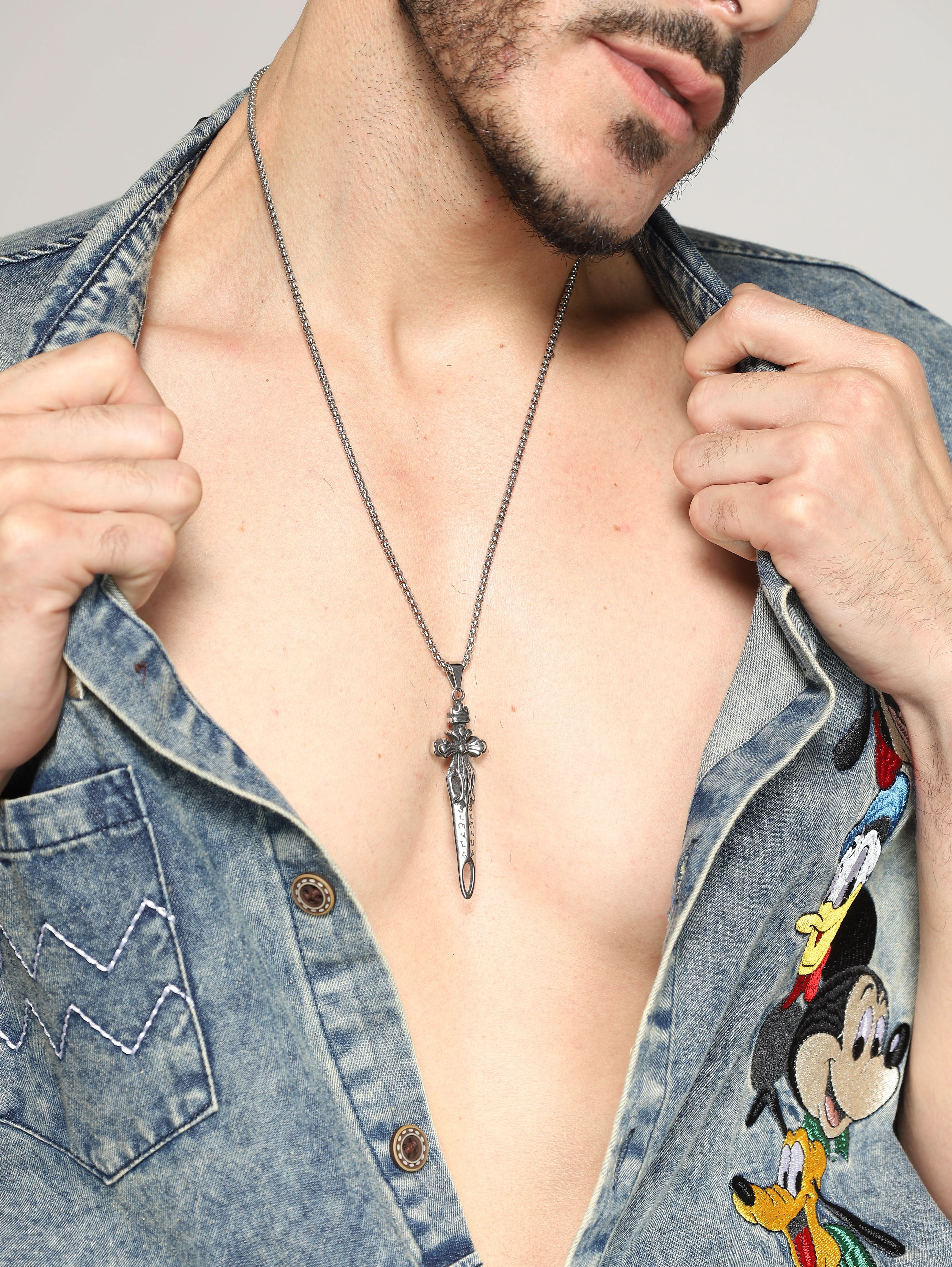 Model wearing Sword Pendant in silver — men's silver pendant styled on hand