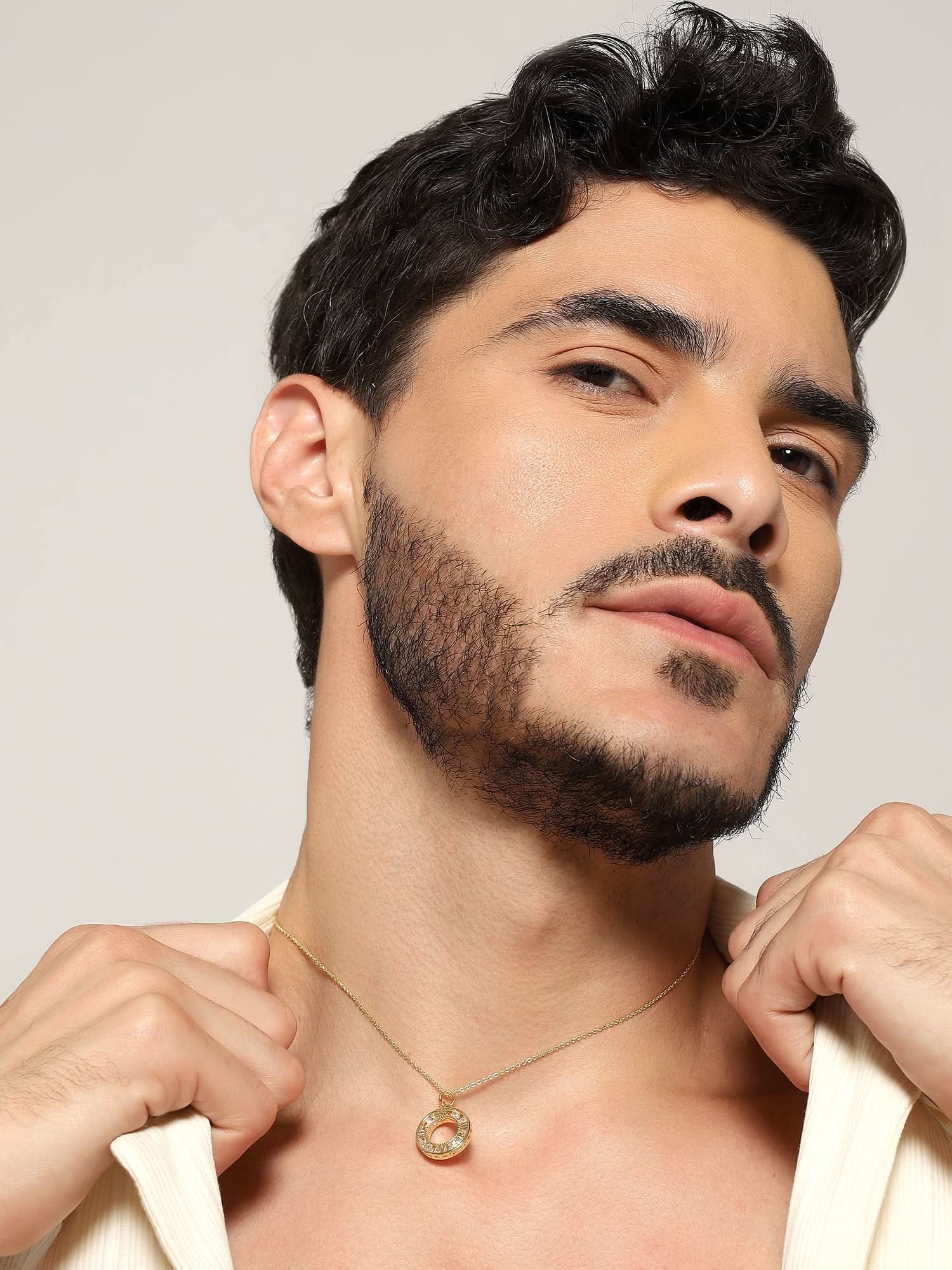 Model wearing Zenith Orb Circle Pendant in gold — men's gold pendant styled on hand