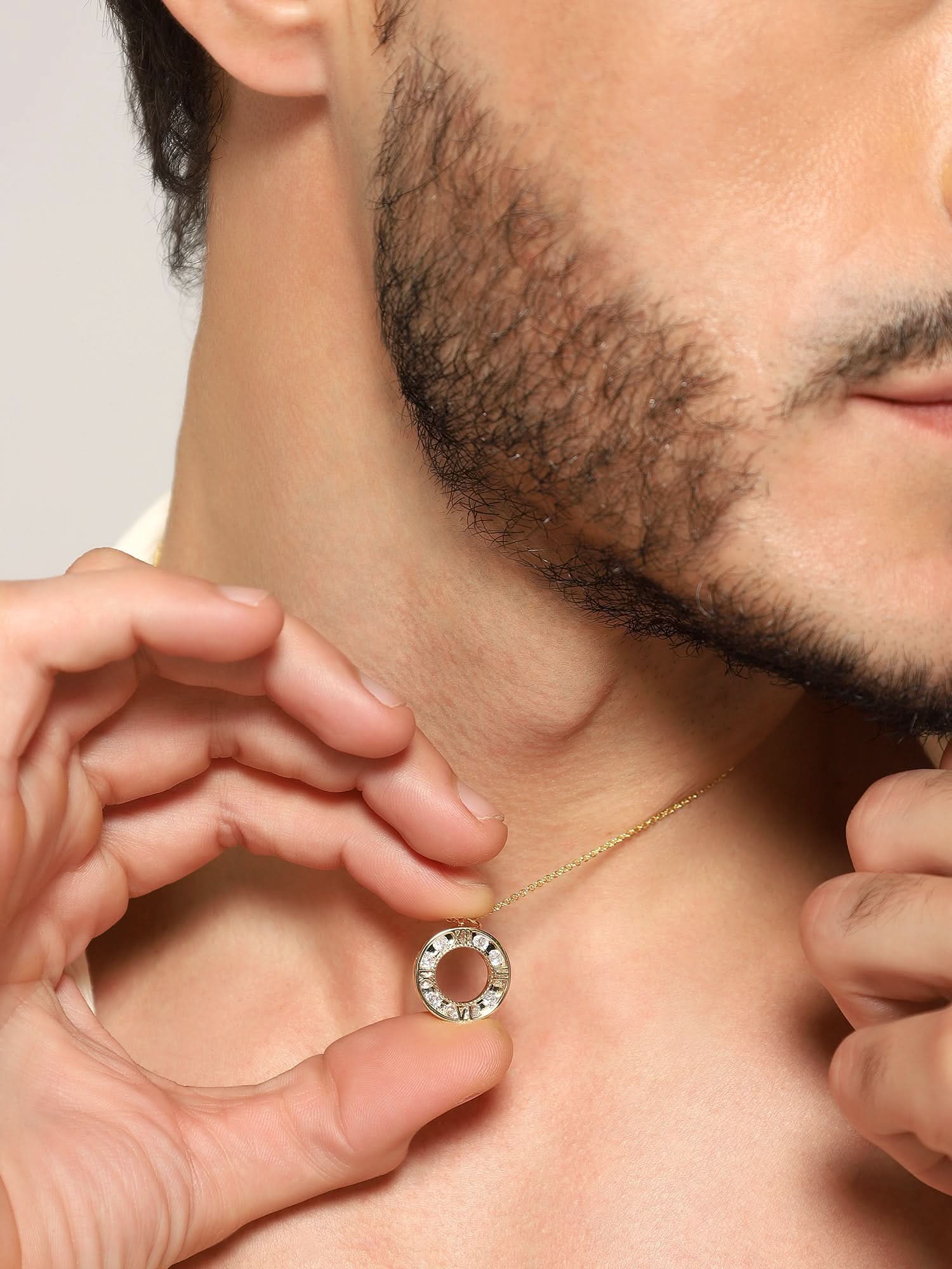 Model wearing Zenith Orb Circle Pendant in gold — men's gold pendant styled on hand