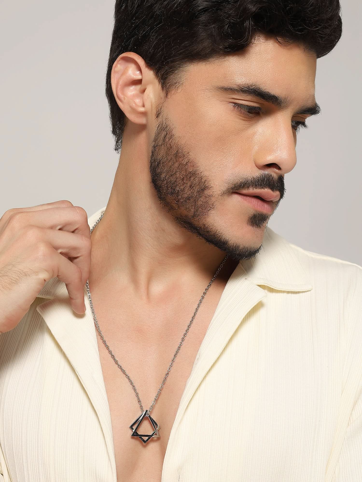 Model wearing Square Triangle Designer Pendant in silver — men's silver pendant styled on hand