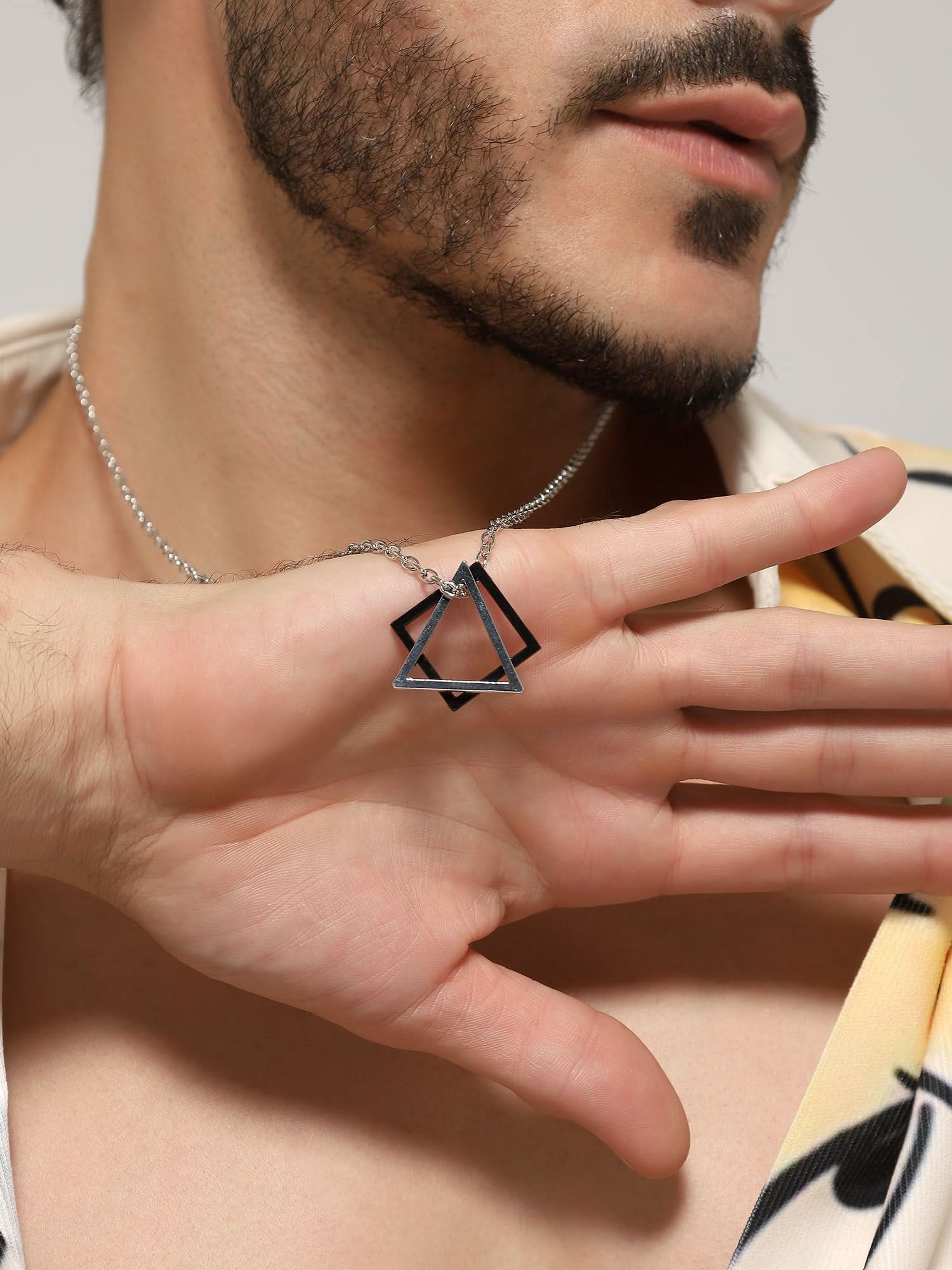 Model wearing Square Triangle Designer Pendant in silver black — men's silver black pendant styled on hand