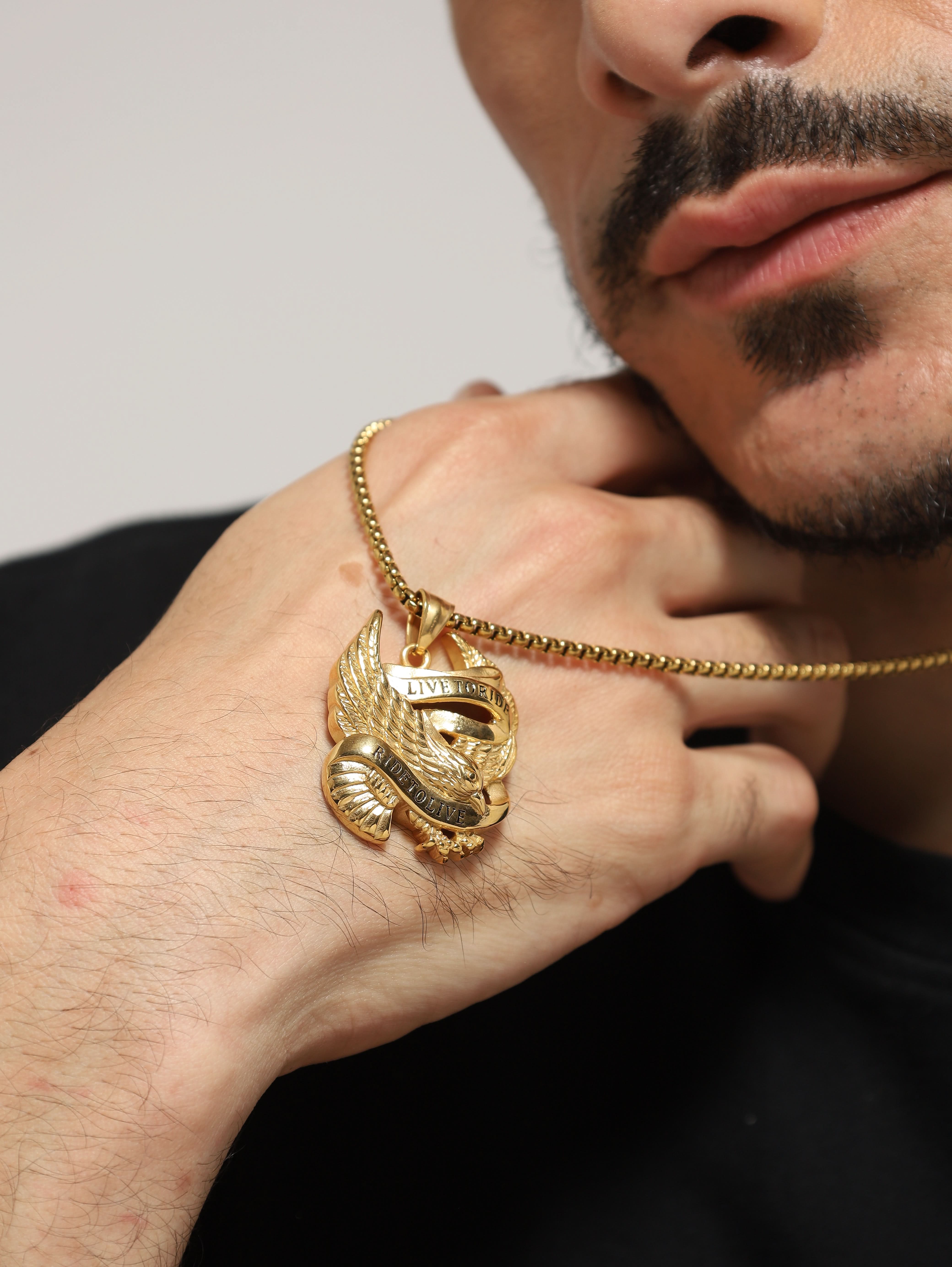 Model wearing Biker Spirit Rider Pendant in gold — men's gold pendant styled on hand