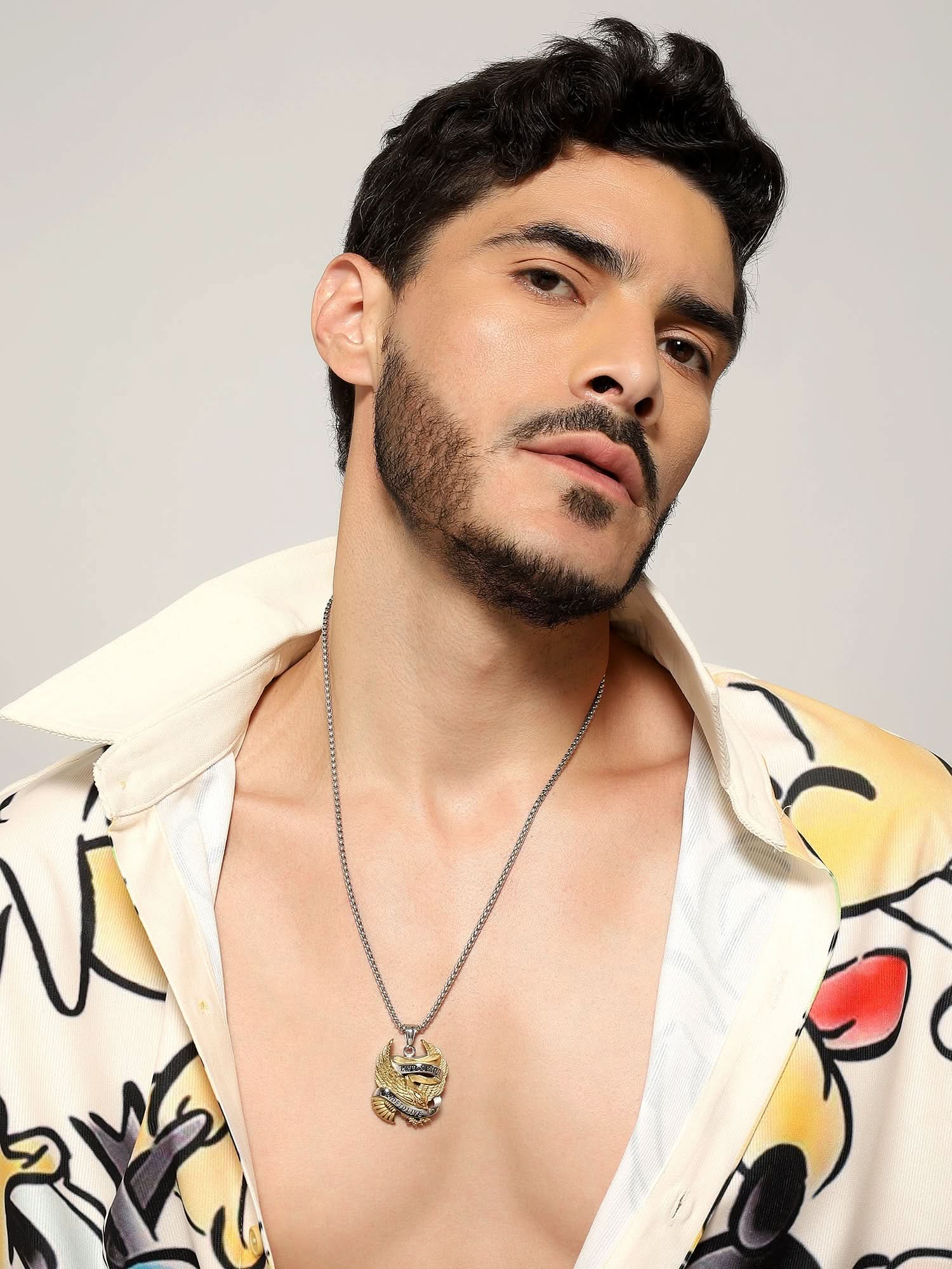 Model wearing Biker Spirit Rider Pendant in silver gold — men's silver gold pendant styled on hand