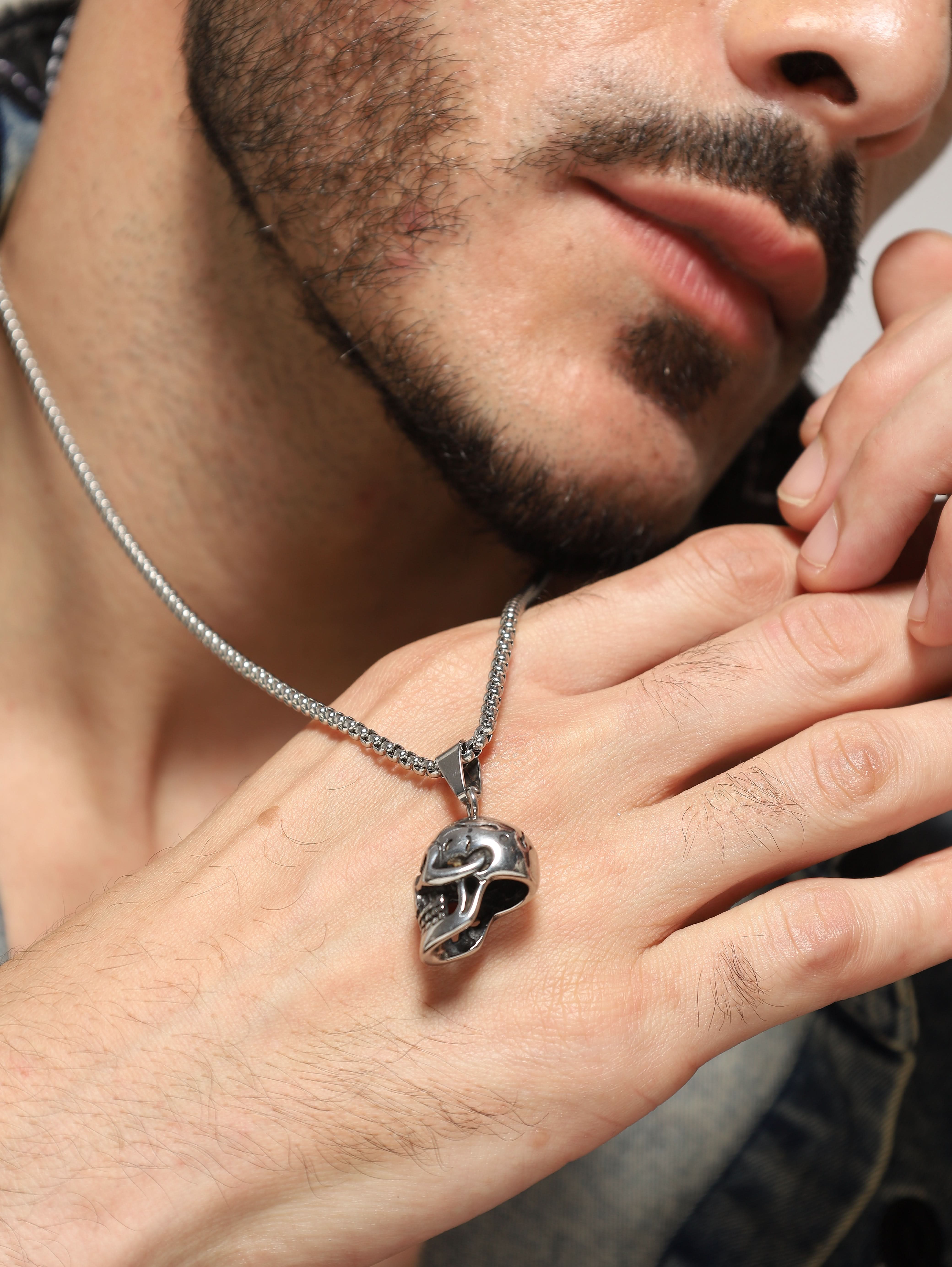 Model wearing Midnight Skull Pendant in silver — men's silver pendant styled on hand