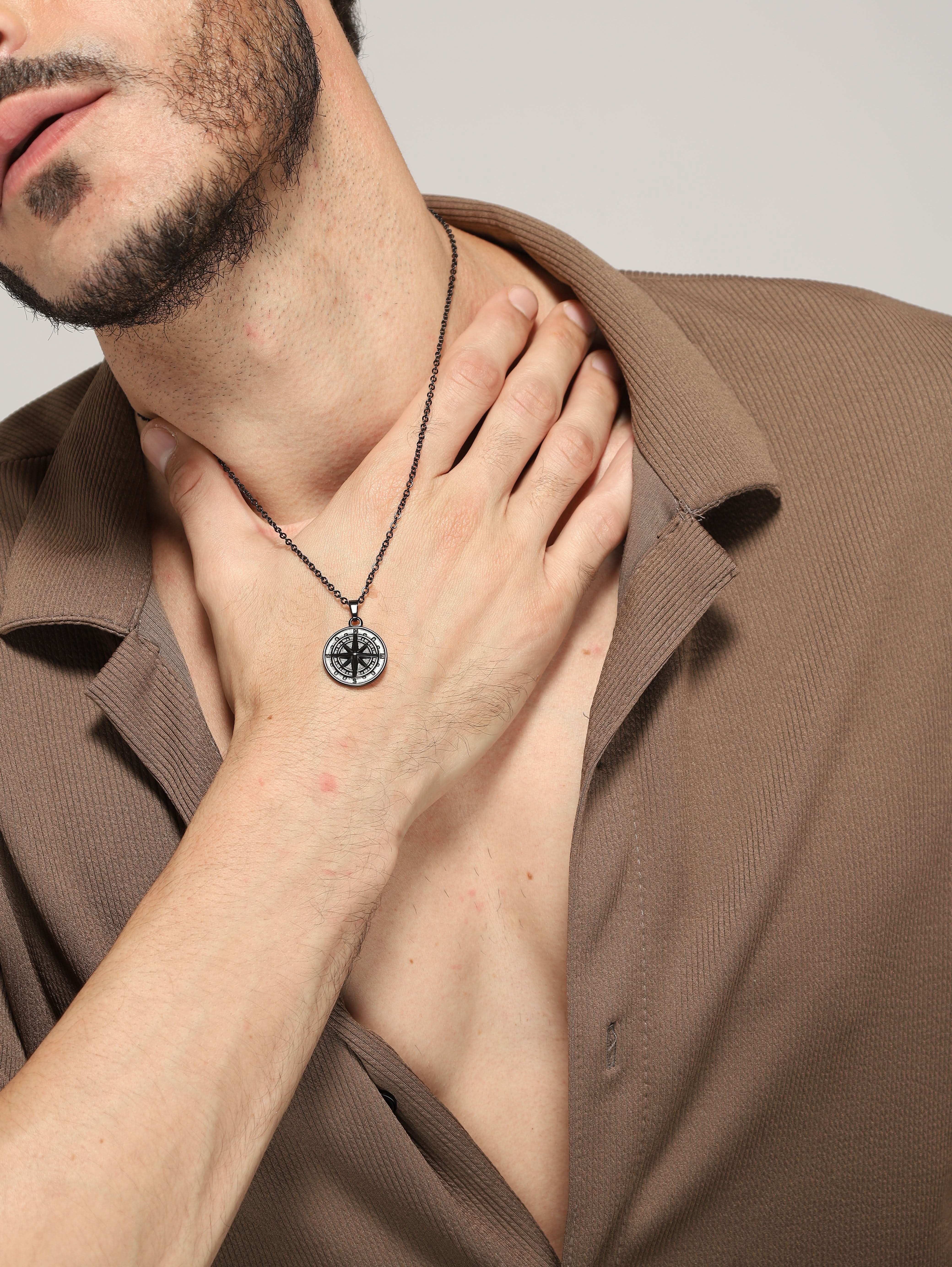 Model wearing North Star Pendant in black — men's black pendant styled on hand