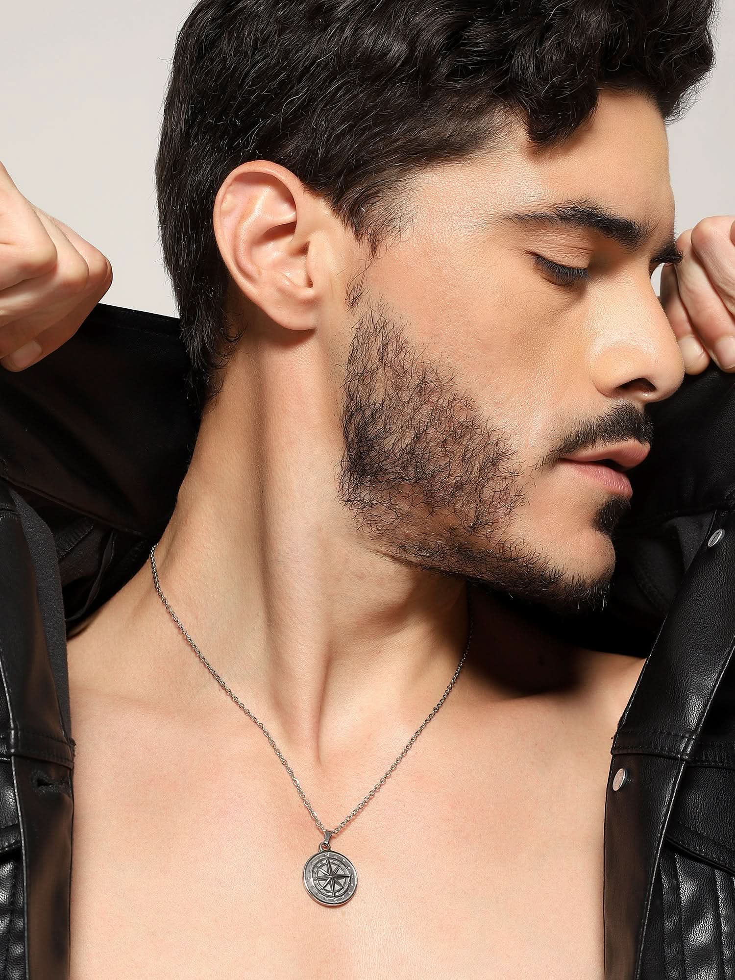 Model wearing North Star Pendant in silver — men's silver pendant styled on hand