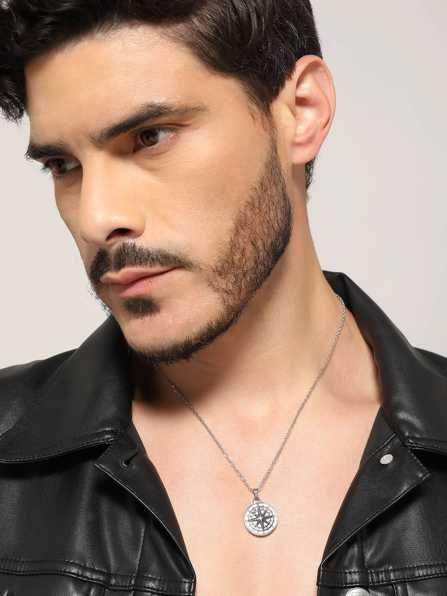 Model wearing North Star Pendant in silver — men's silver pendant styled on hand