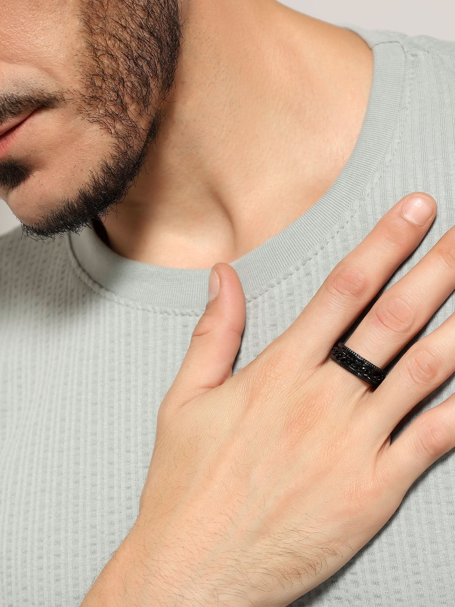 Model wearing Open Bottle Spinner Ring in black — men's black ring styled on hand