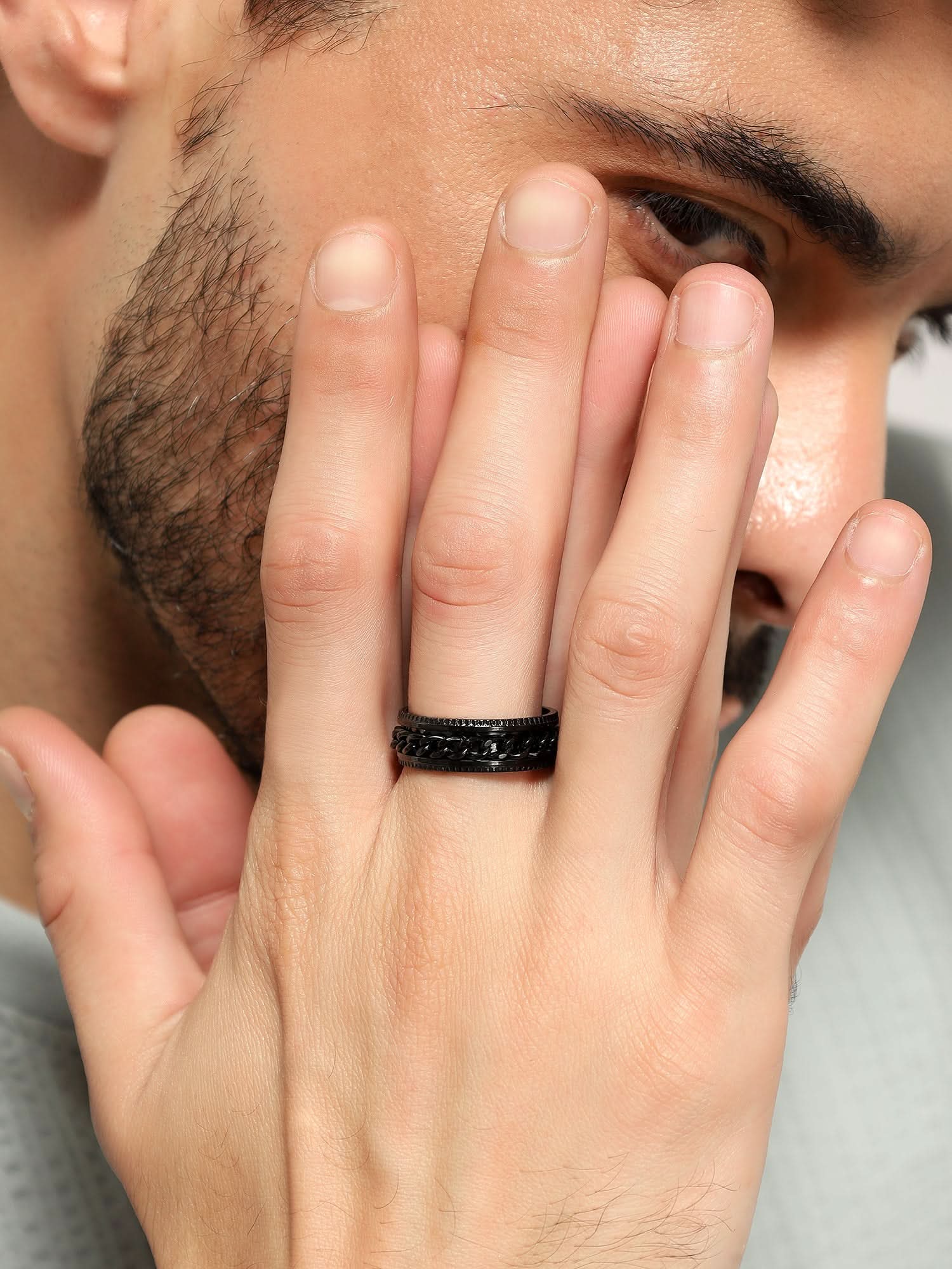 Model wearing Open Bottle Spinner Ring in black — men's black ring styled on hand