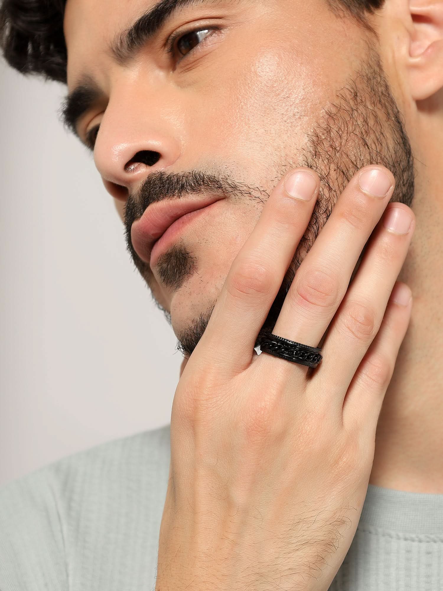 Model wearing Open Bottle Spinner Ring in black — men's black ring styled on hand