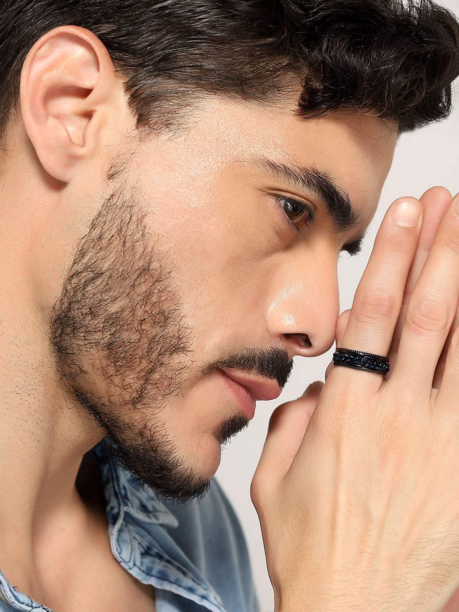 Model wearing Open Bottle Spinner Ring in blue black — men's blue black ring styled on hand