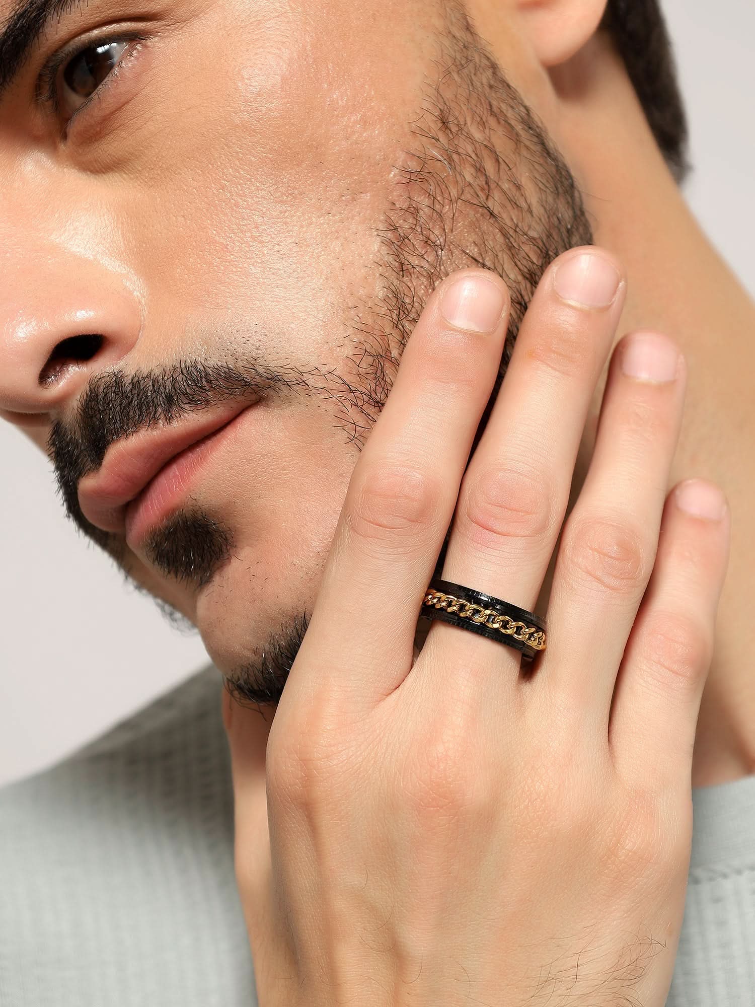 Model wearing Open Bottle Spinner Ring in gold black — men's gold black ring styled on hand