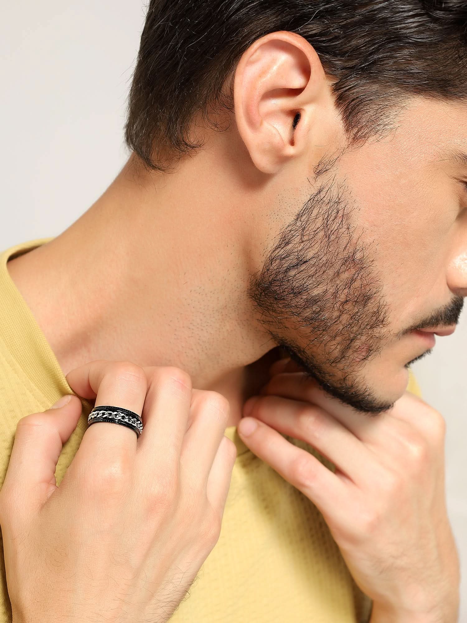 Model wearing Open Bottle Spinner Ring in silver black — men's silver black ring styled on hand