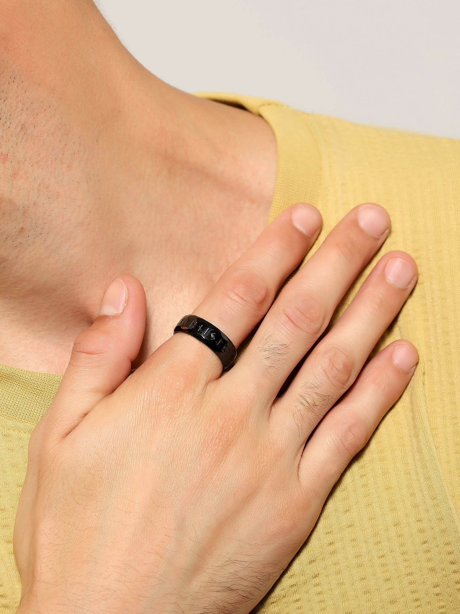 Model wearing Ancient Retro Ring in black — men's black ring styled on hand