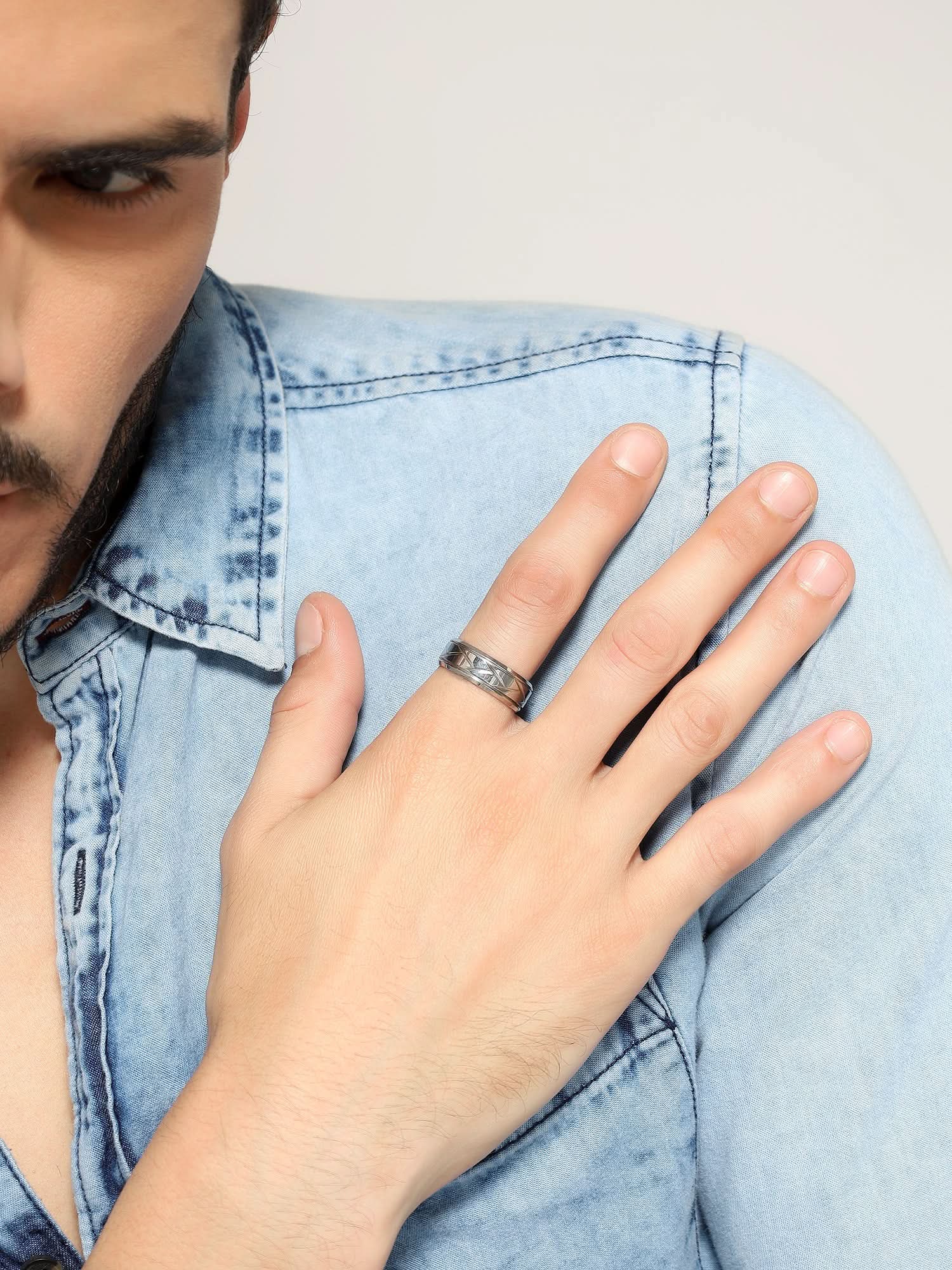 Model wearing Crisscross Ring in silver — men's silver ring styled on hand