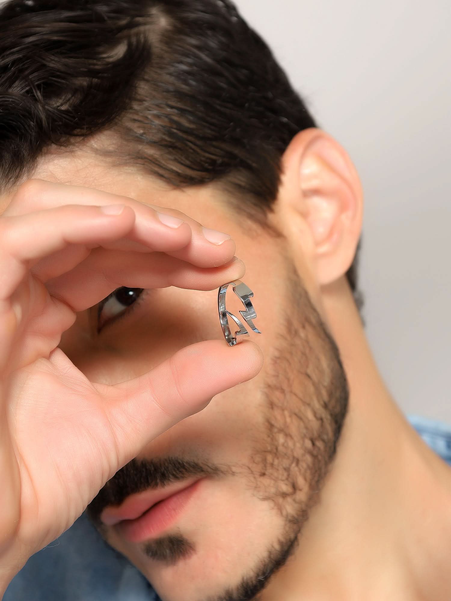 Model wearing Lightning Split Ring in silver — men's silver ring styled on hand