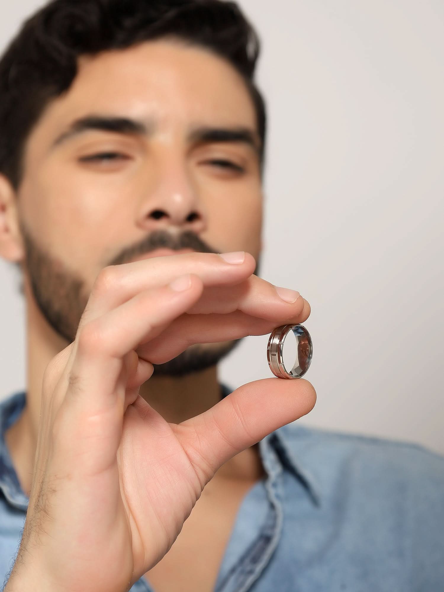 Model wearing Tungsten Pattern Ring in silver — men's silver ring styled on hand