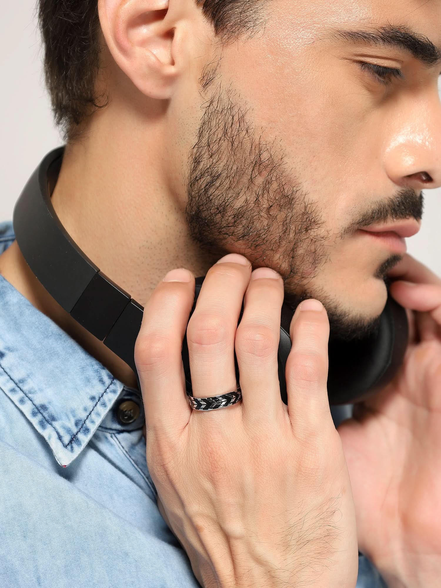 Model wearing Tyre Pattern Ring in silver — men's silver ring styled on hand
