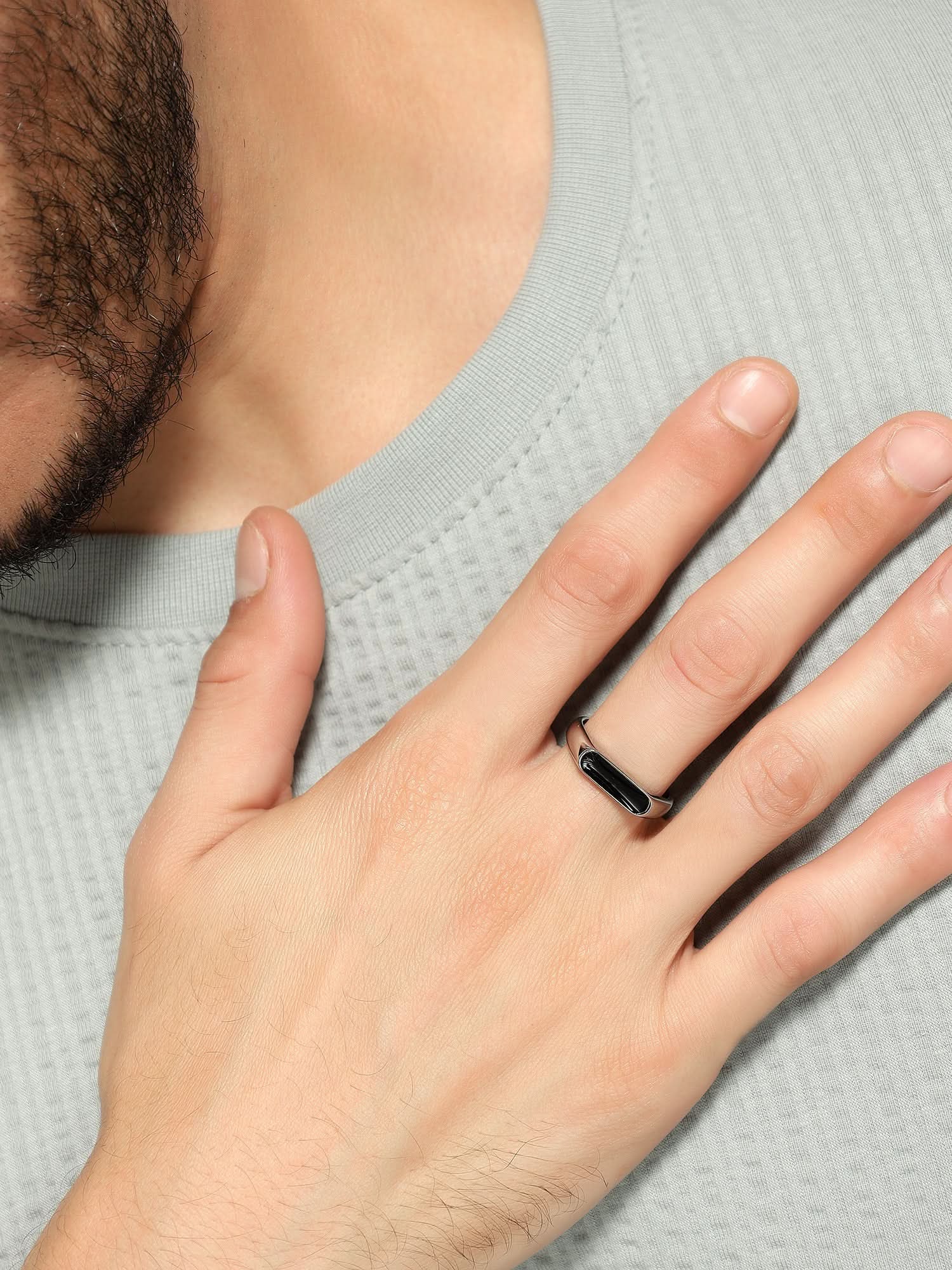Model wearing Crown Fing Ring in silver — men's silver ring styled on hand