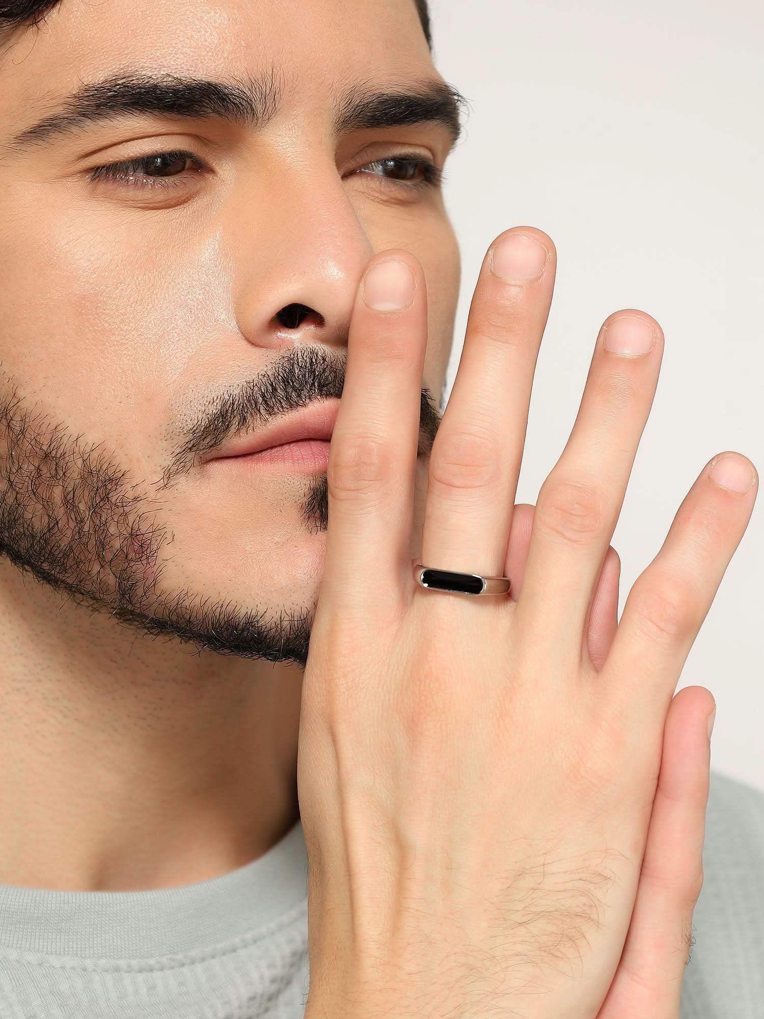Model wearing Crown Fing Ring in silver — men's silver ring styled on hand