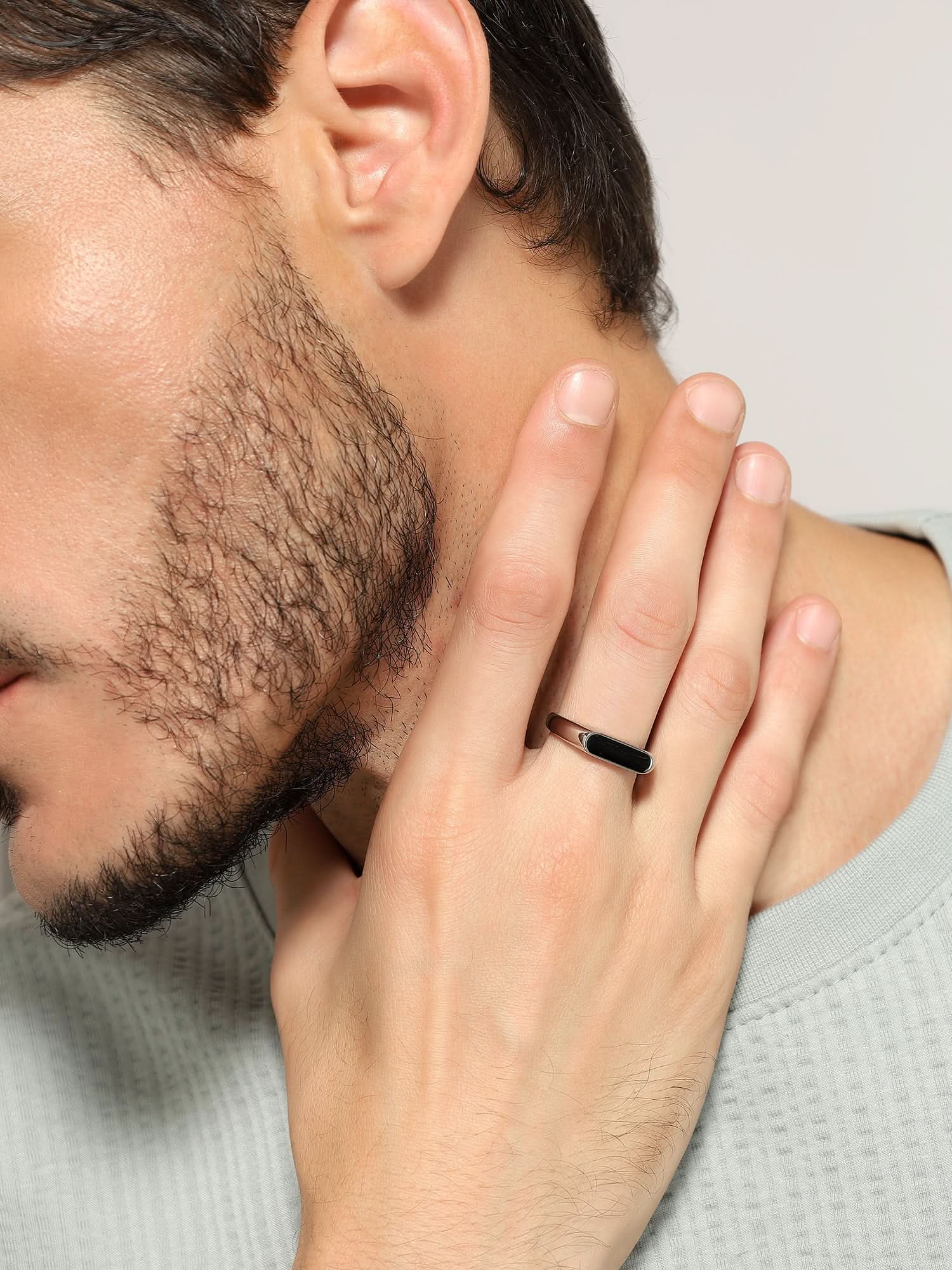 Model wearing Crown Fing Ring in silver — men's silver ring styled on hand