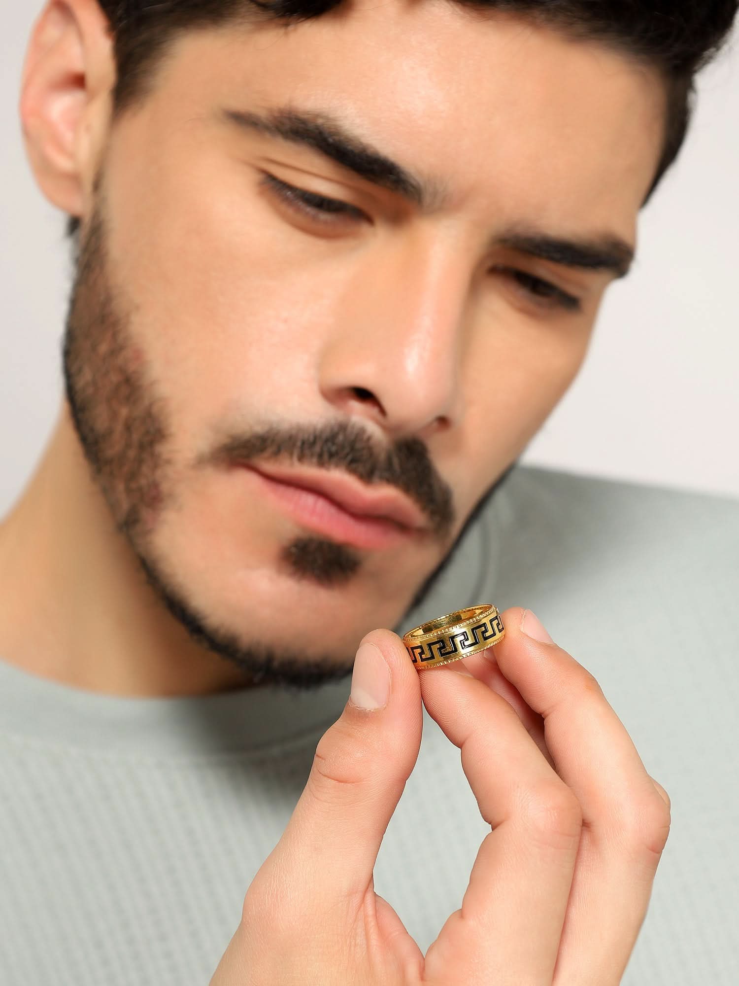 Model wearing Pattern Ring in gold — men's gold ring styled on hand