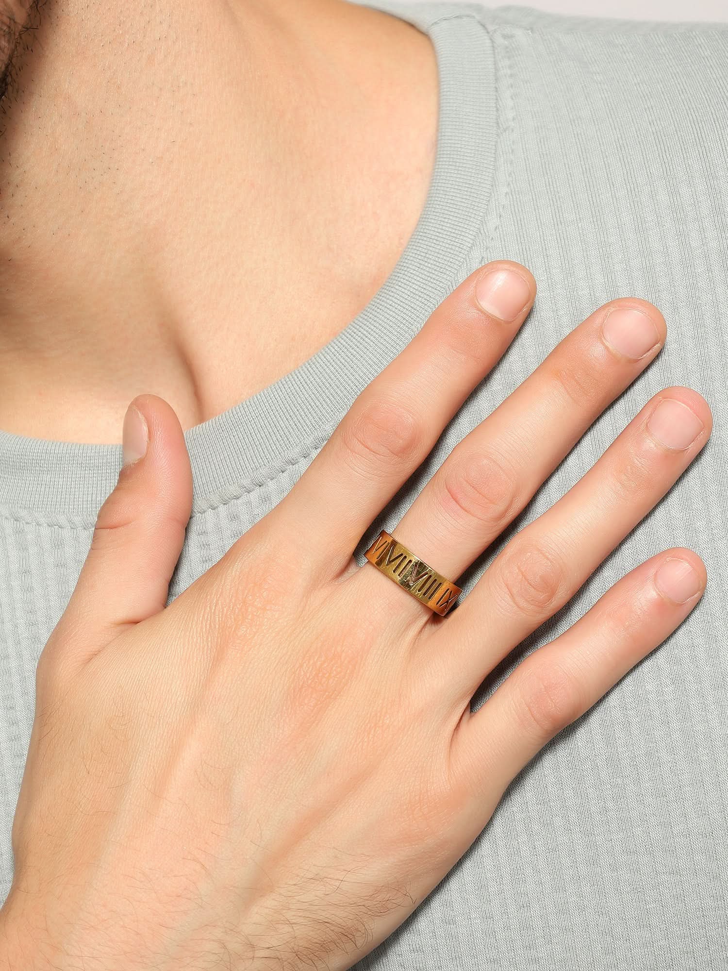 Model wearing Roman Numerals Ring in gold — men's gold ring styled on hand